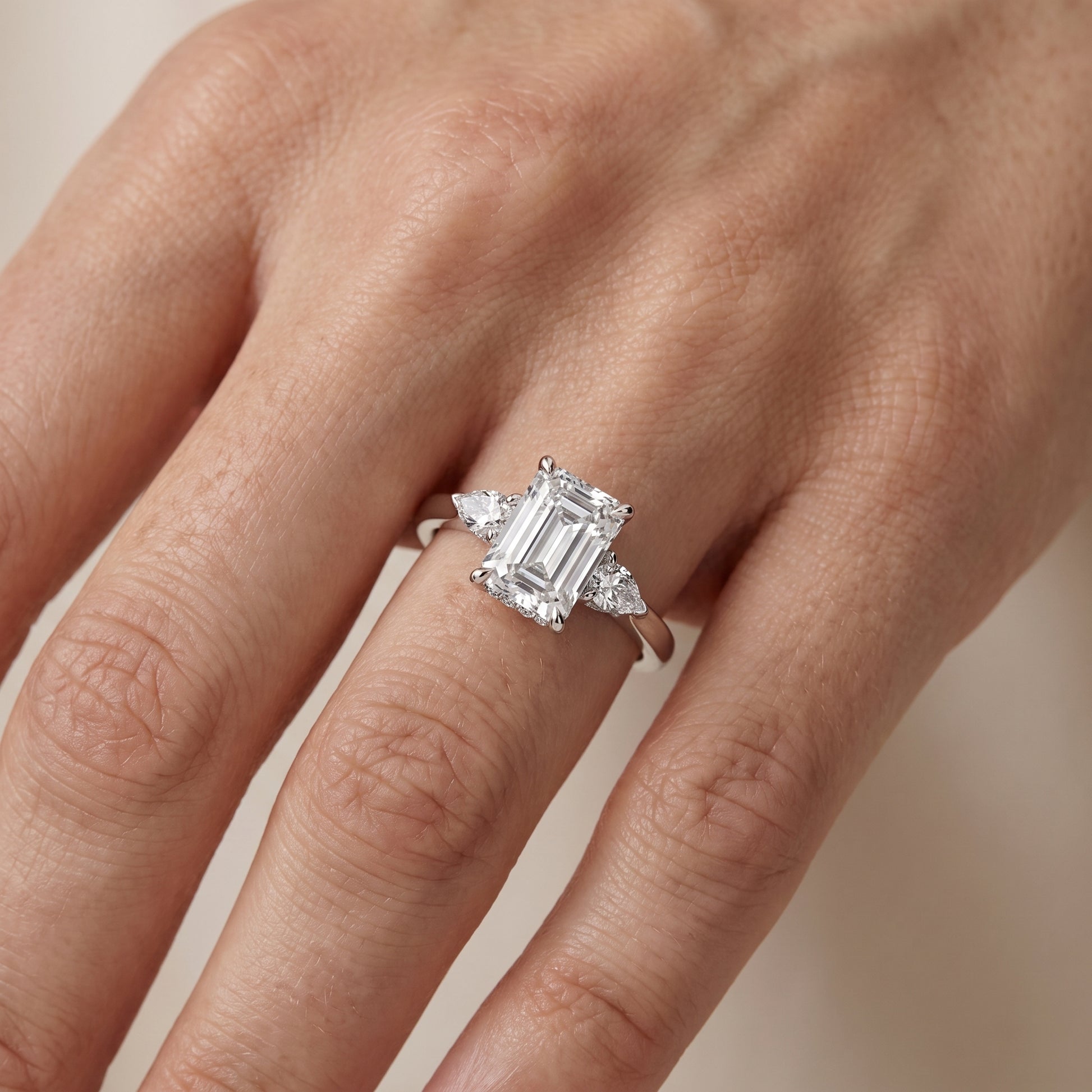 Leila Three-Stone Emerald Diamond Engagement Ring in Platinum - lifestyle.jpg