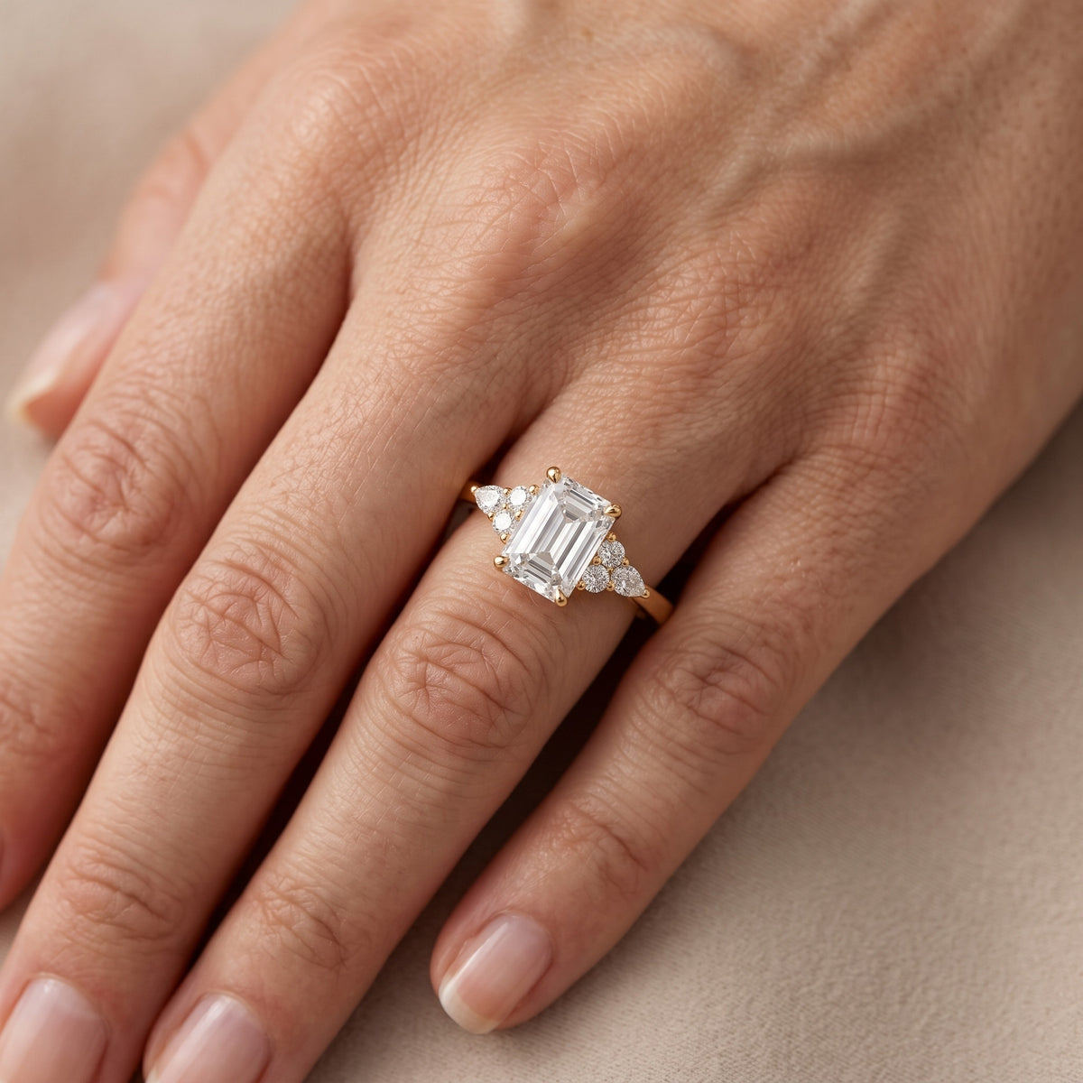 Amelia Three Stone Emerald Diamond Engagement Ring in Yellow Gold - lifestyle.jpg