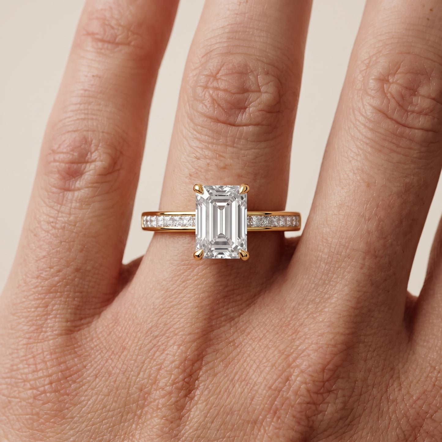 Maren Sidestone Channel Set Emerald Diamond Engagement Ring in Yellow Gold - lifestyle.jpg