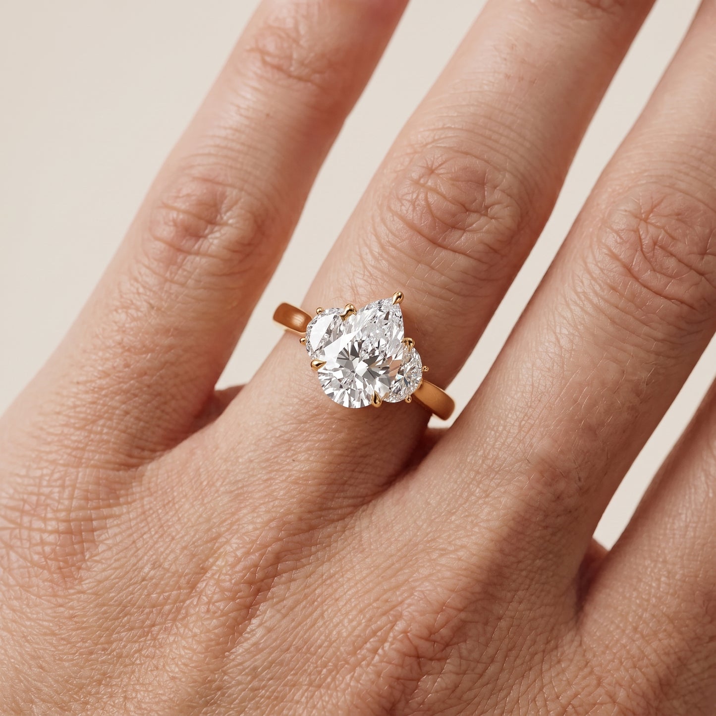 Romy Three-Stone Pear Diamond Engagement Ring in Yellow Gold - lifestyle.jpg