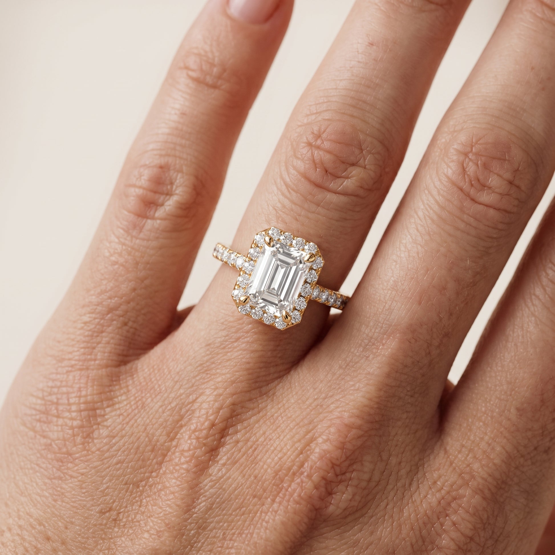 Amara Halo Claw Prong Emerald Diamond Ring in Yellow Gold - lifestyle.jpg