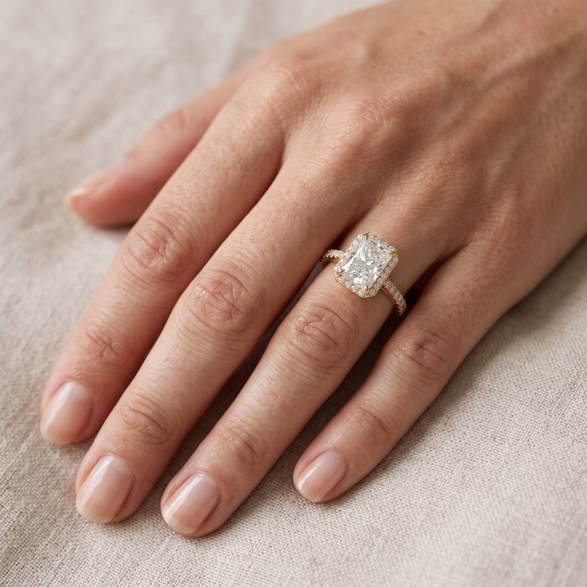 Alma Halo Pavé Radiant Diamond Engagement Ring in Yellow Gold - lifestyle.jpg