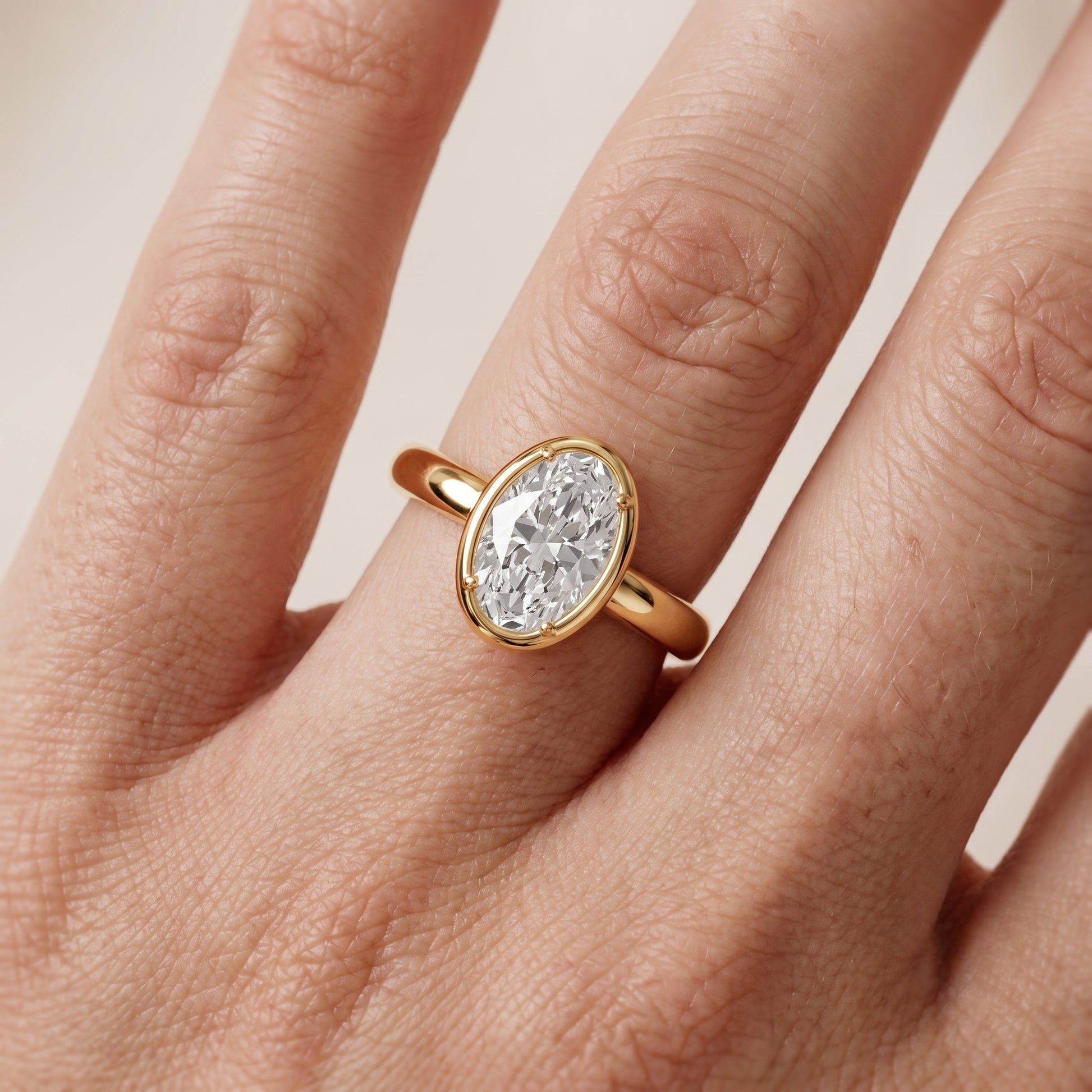 Alina Bezel Solitaire Oval Diamond Ring in Yellow Gold - lifestyle.jpg