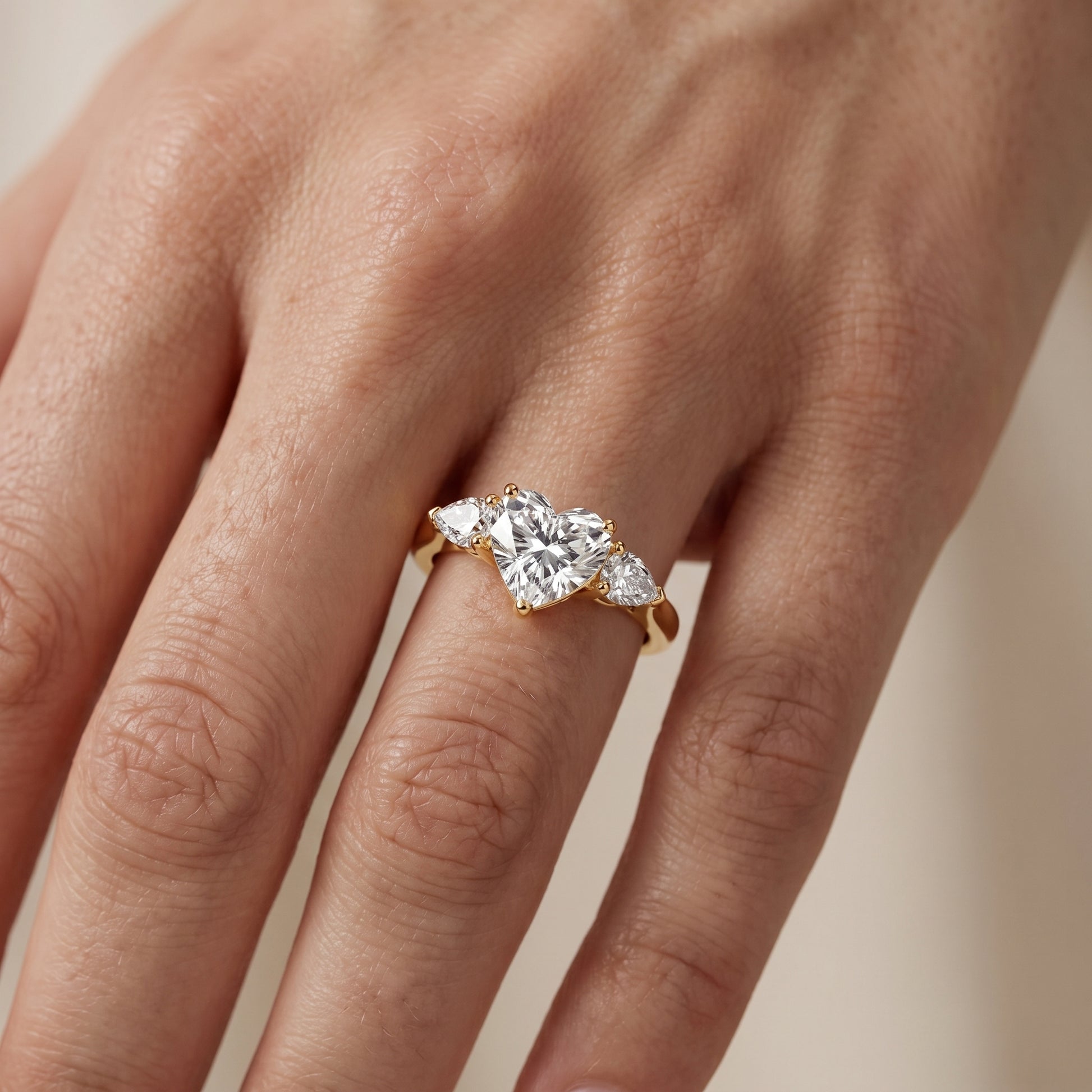 Mirabel Three-Stone Heart Diamond Engagement Ring in Yellow Gold - lifestyle.jpg