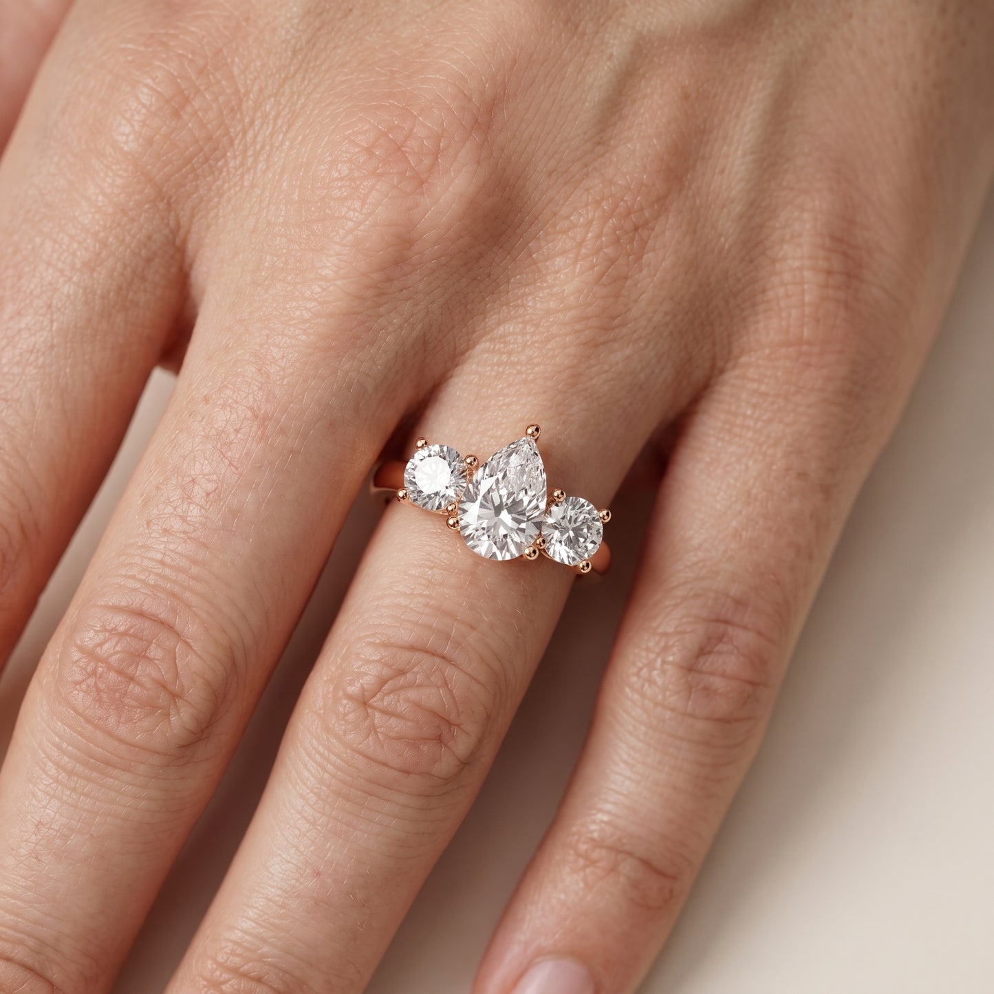 Callie Three-Stone Trellis Pear Diamond Engagement Ring in Rose Gold - lifestyle.jpg