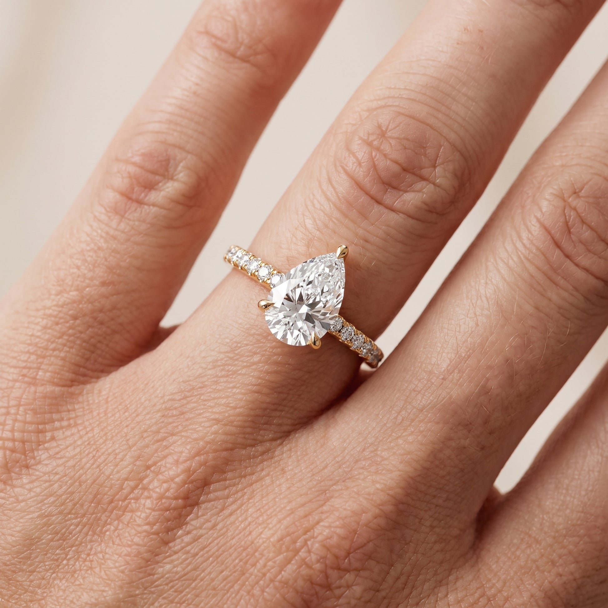 Maya Hidden Halo Pavé Pear Diamond Engagement Ring in Yellow Gold - lifestyle.jpg
