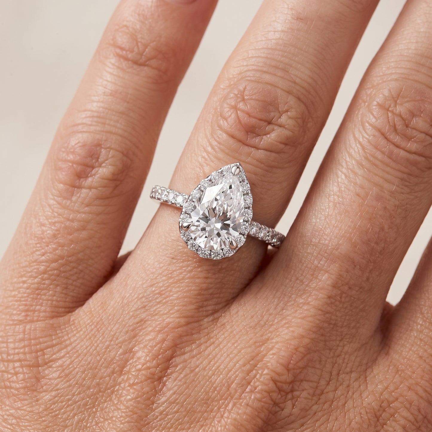 Amara Halo Claw Prong Pear Diamond Ring in Platinum - lifestyle.jpg