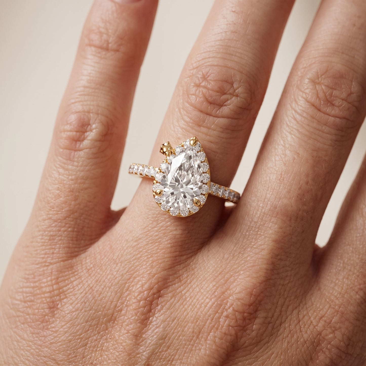Amara Halo Claw Prong Pear Diamond Ring in Yellow Gold - lifestyle.jpg