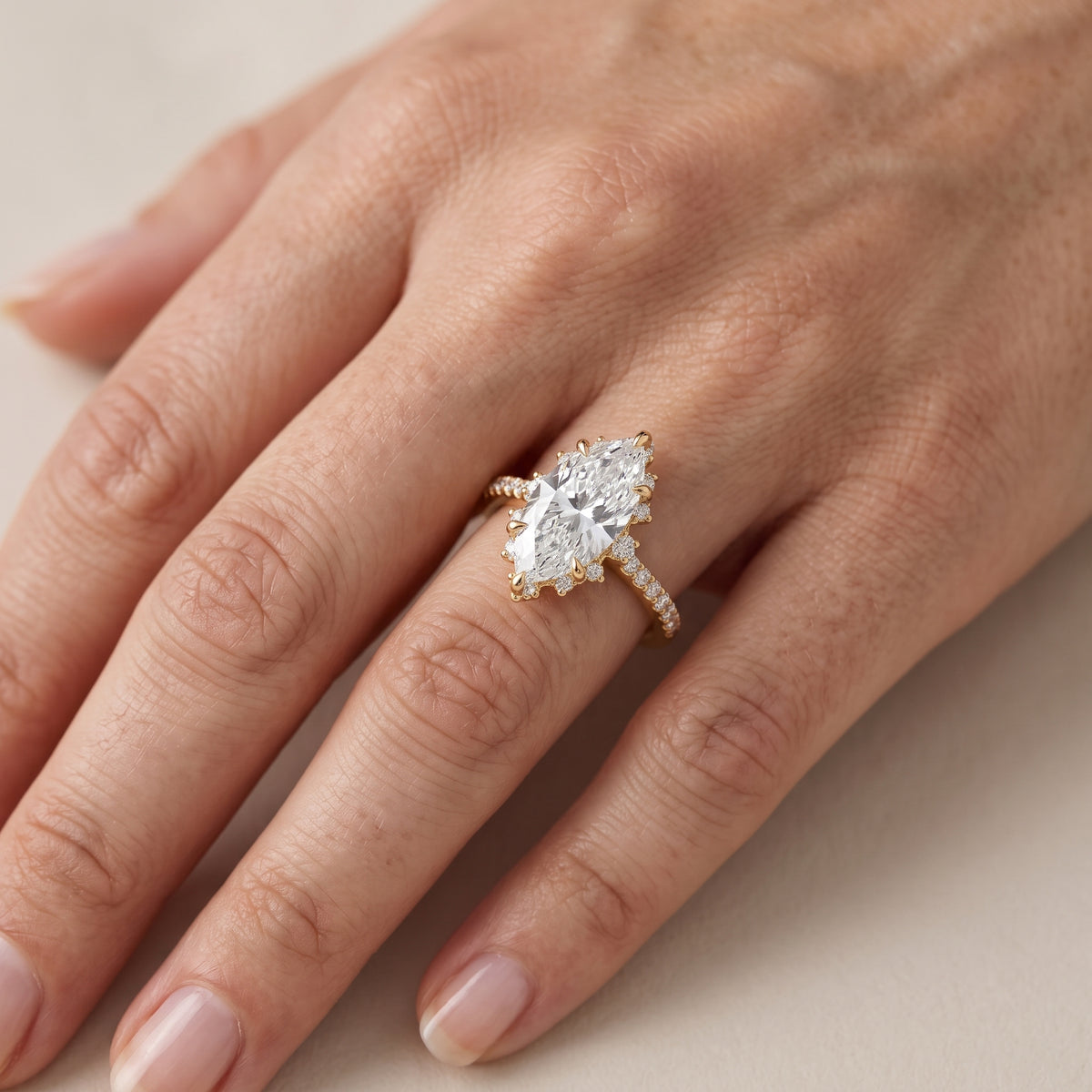 Leonie Starburst Halo Marquise Diamond Engagement Ring in Yellow Gold - lifestyle.jpg