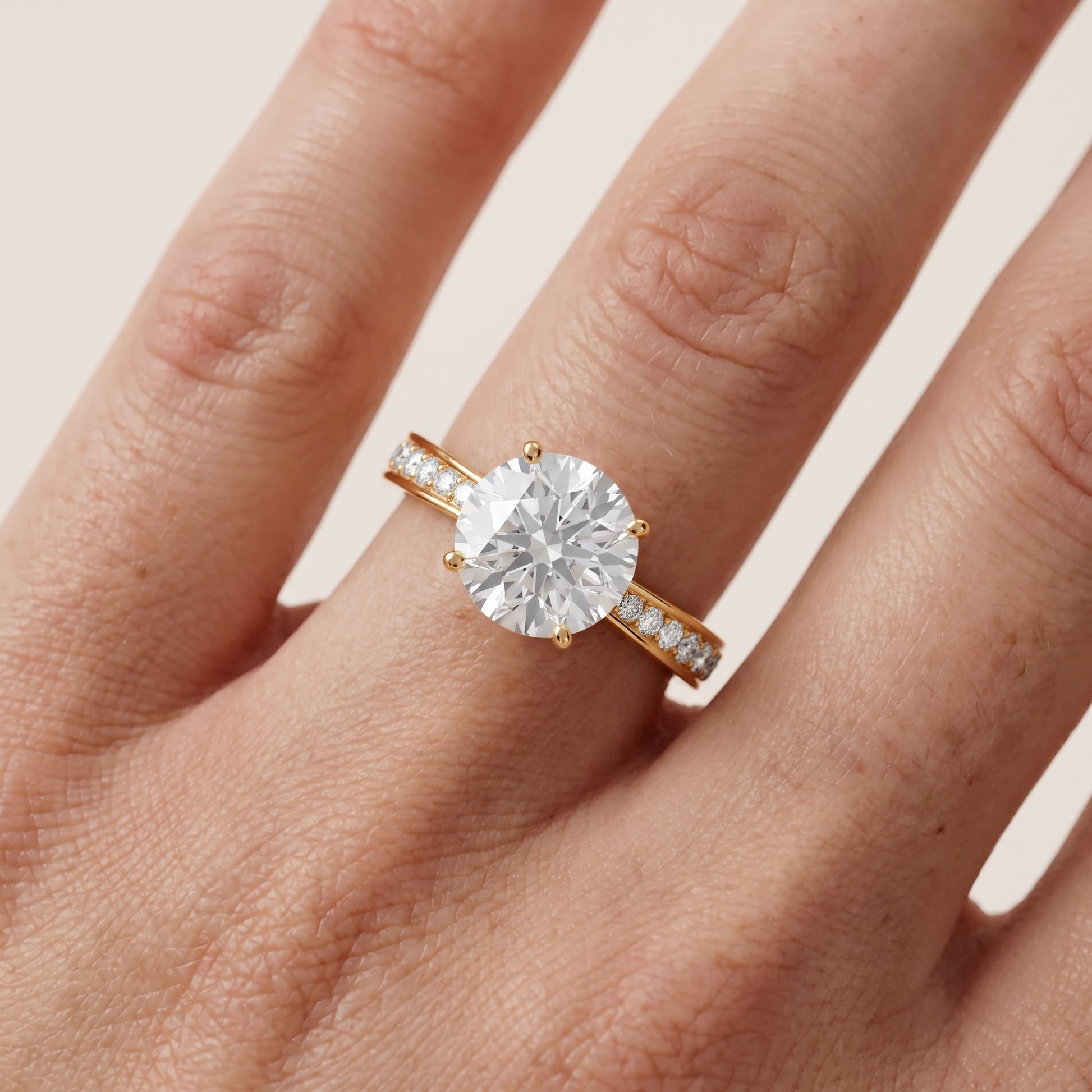 Rhea Sidestone Pavé Round Diamond Engagement Ring in Yellow Gold - lifestyle.jpg