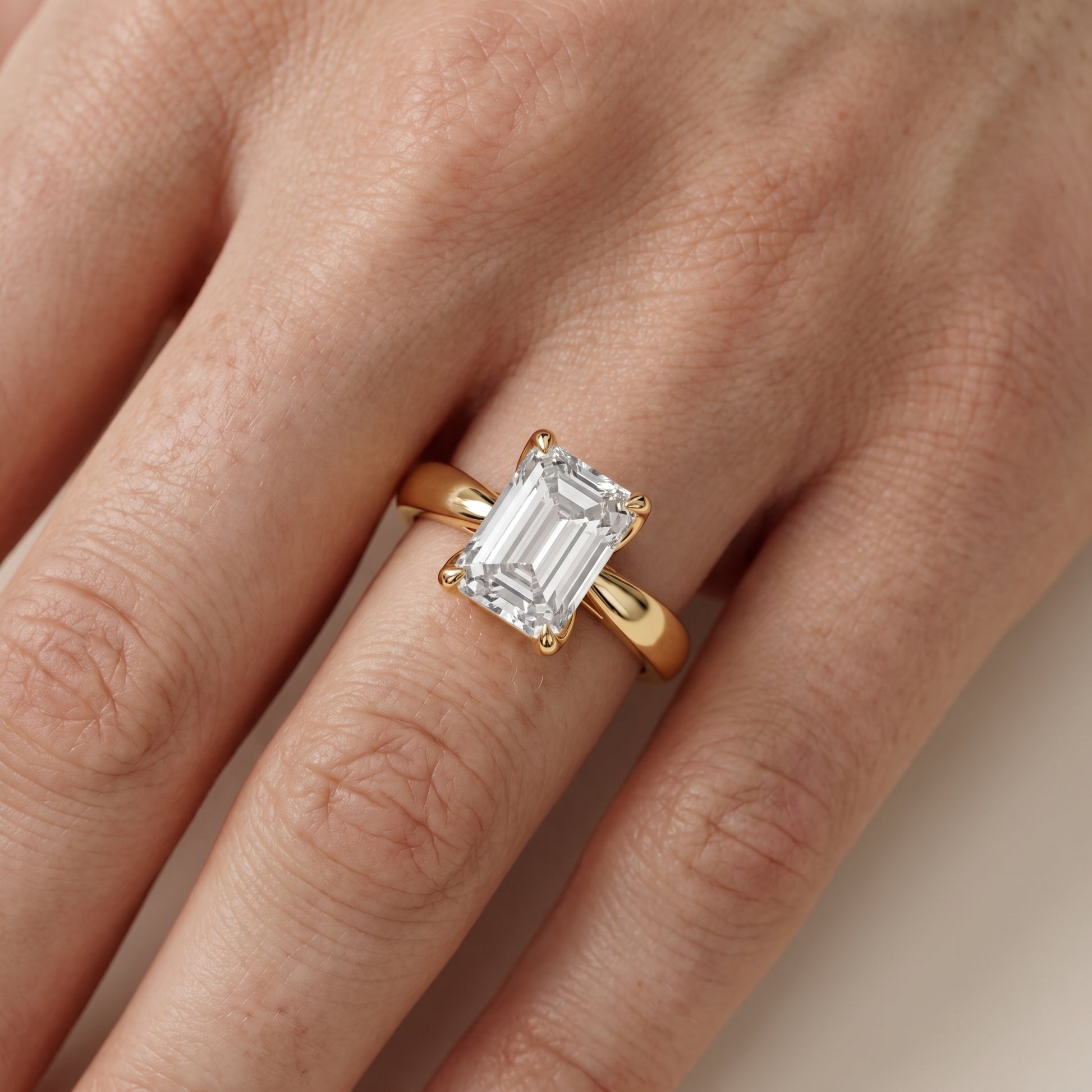 Lucia Solitaire Six-Prong Emerald Diamond Engagement Ring in Yellow Gold - lifestyle.jpg