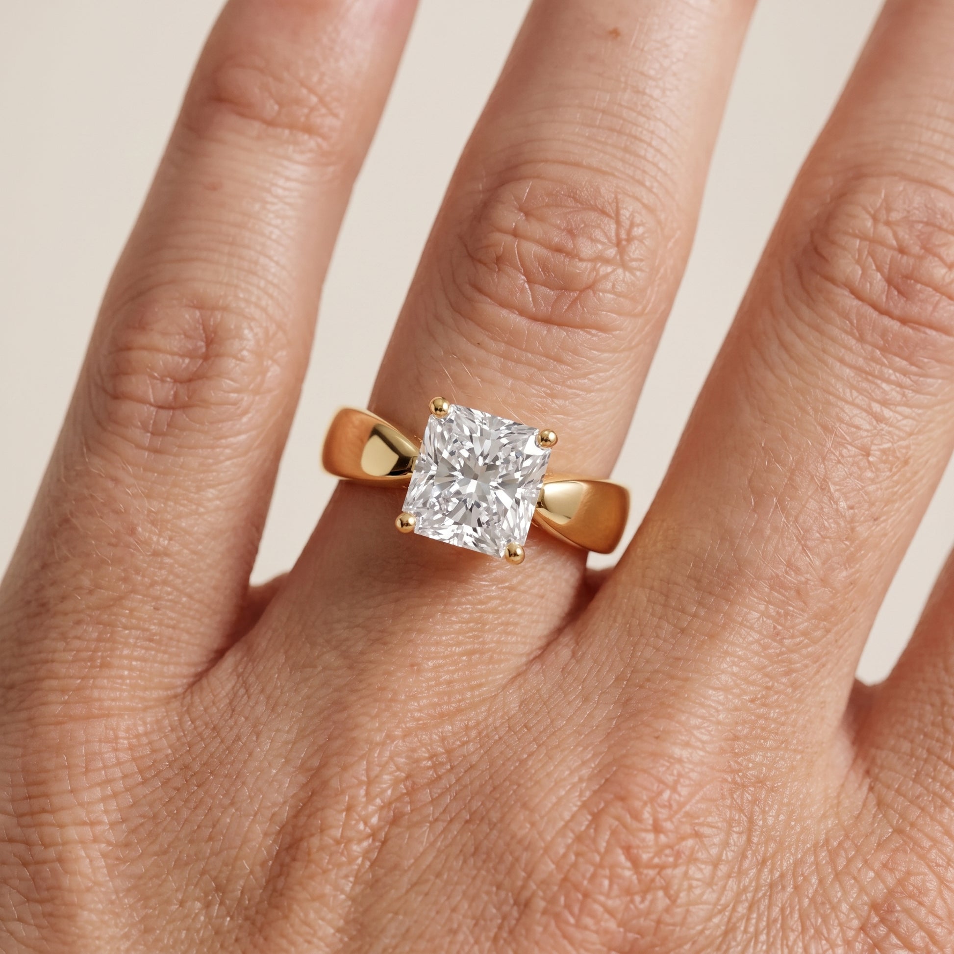 Talia Solitaire Twist Radiant Diamond Engagement Ring in Yellow Gold - lifestyle.jpg