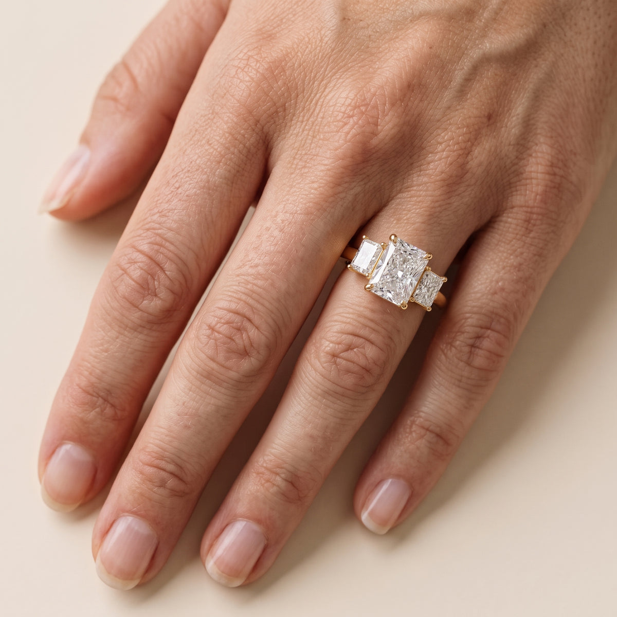 Zoe Three-Stone Radiant Diamond Engagement Ring in Yellow Gold - lifestyle.jpg