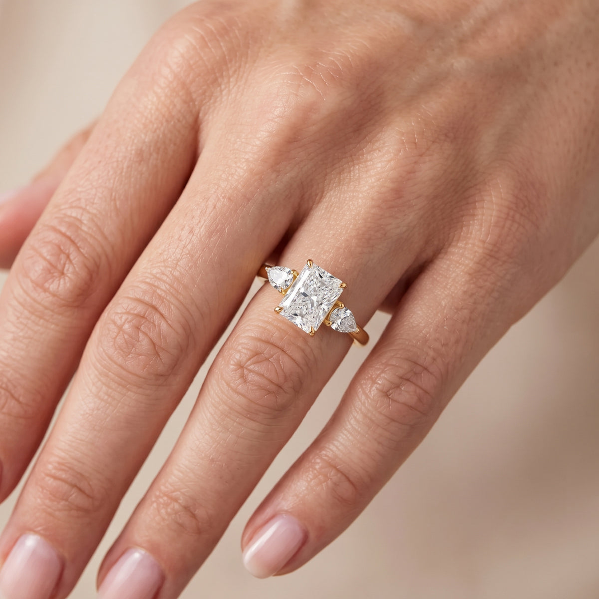 Stella Three-Stone Radiant Diamond Engagement Ring in Yellow Gold - lifestyle.jpg