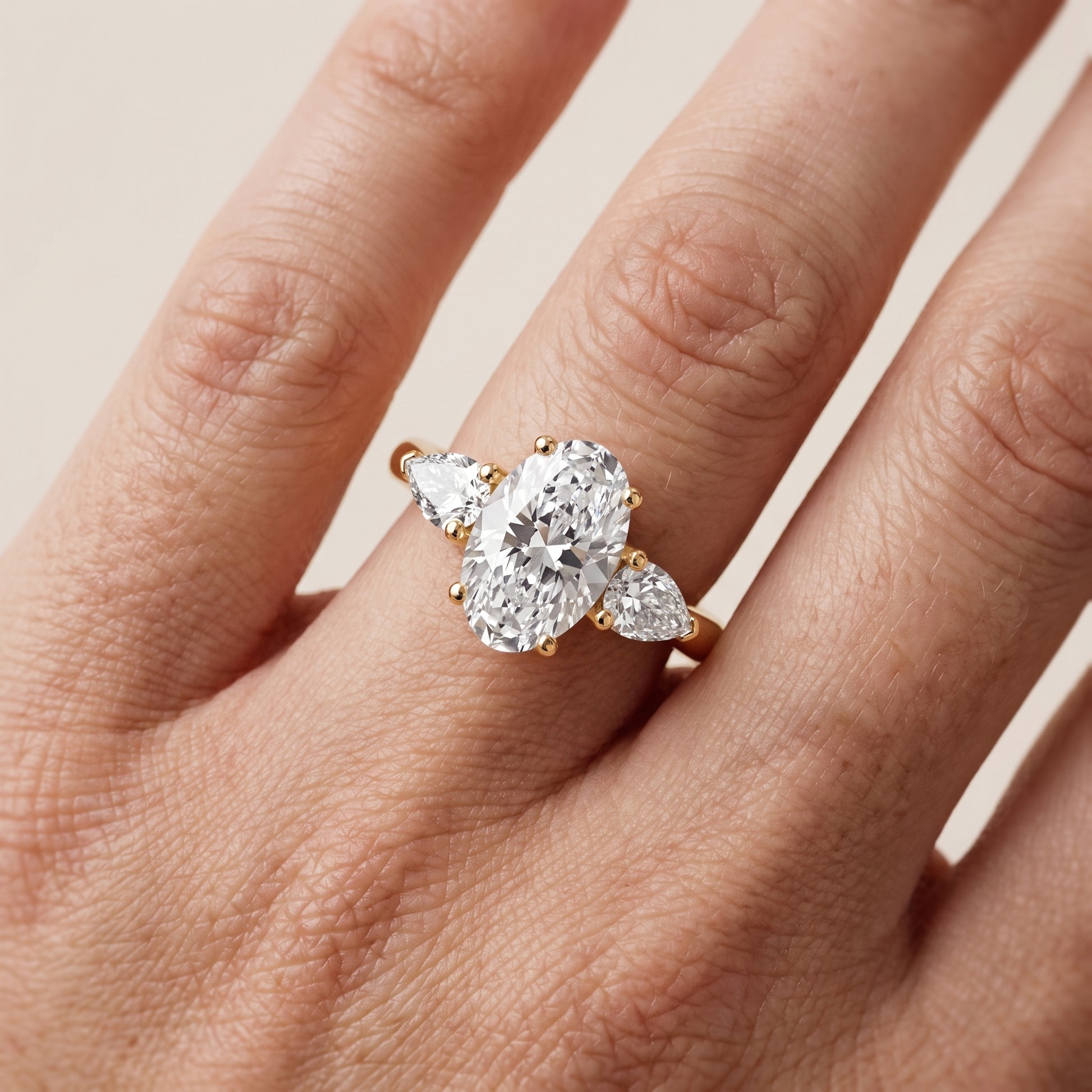Mirabel Three-Stone Oval Diamond Engagement Ring in Yellow Gold - lifestyle.jpg