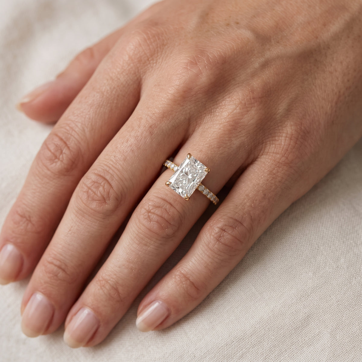 Olivia Solitaire Pavé Radiant Diamond Engagement Ring in Yellow Gold - lifestyle.jpg