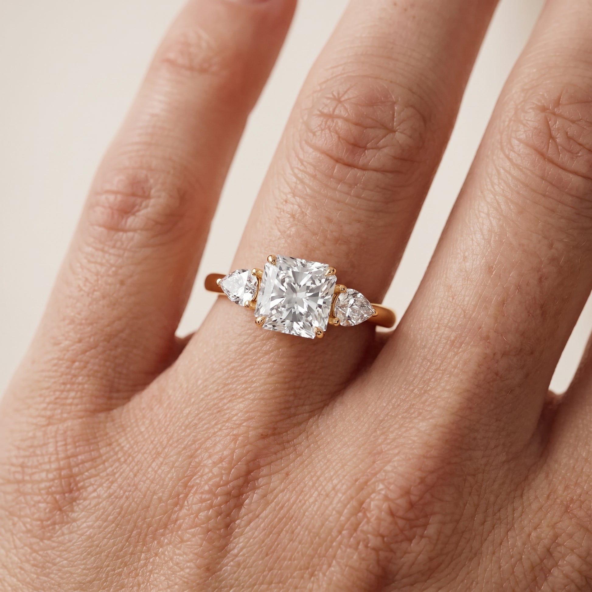 Phoebe Three-Stone Radiant Diamond Ring in Yellow Gold - lifestyle.jpg