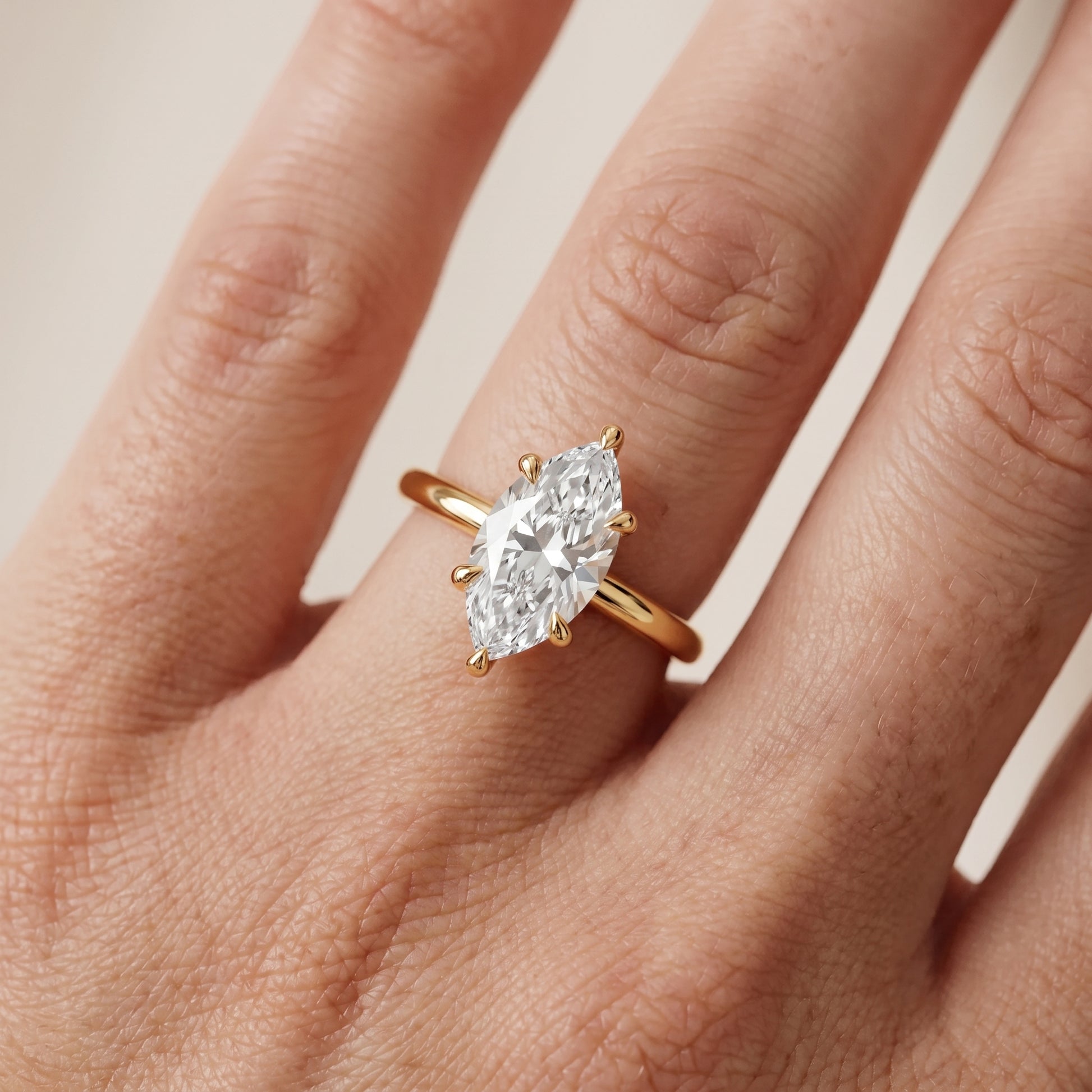 Nella Petite Solitaire Marquise Diamond Engagement Ring in Yellow Gold - lifestyle.jpg