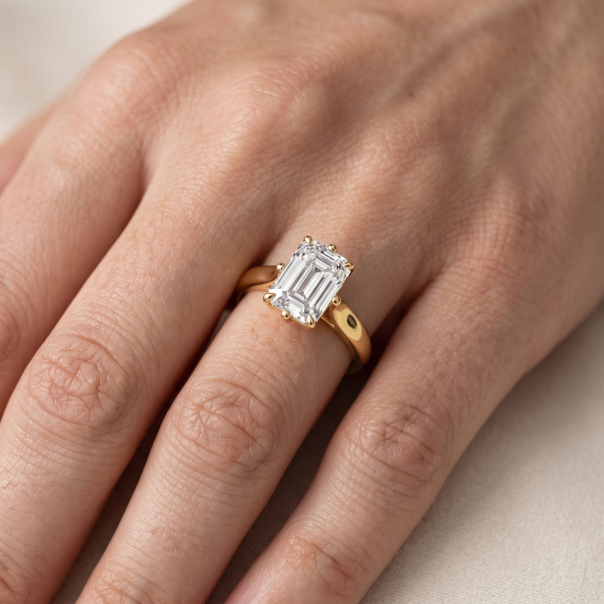 Edwina Crossover Solitaire Emerald Diamond Engagement Ring in Silver - lifestyle.jpg