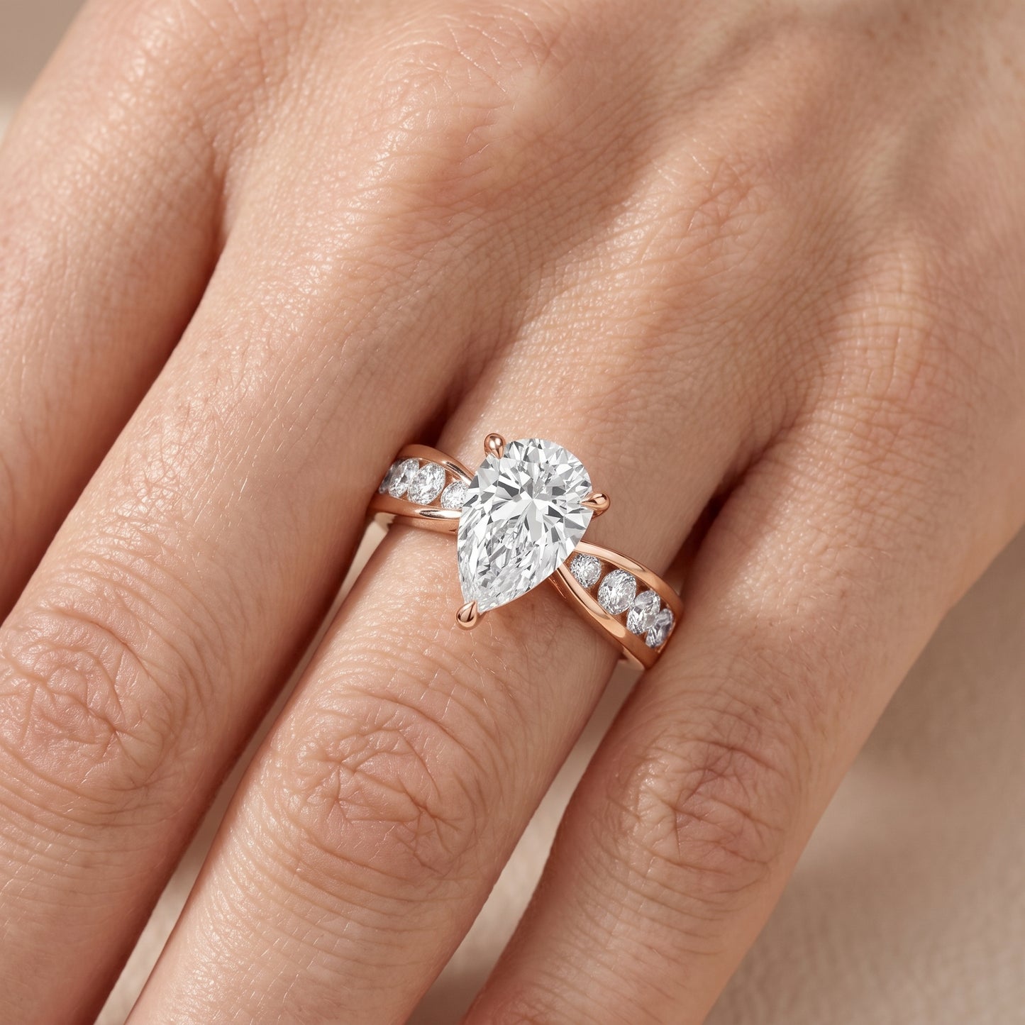 Noor Channel Set Sidestone Pear Diamond Engagement Ring in Rose Gold - lifestyle.jpg