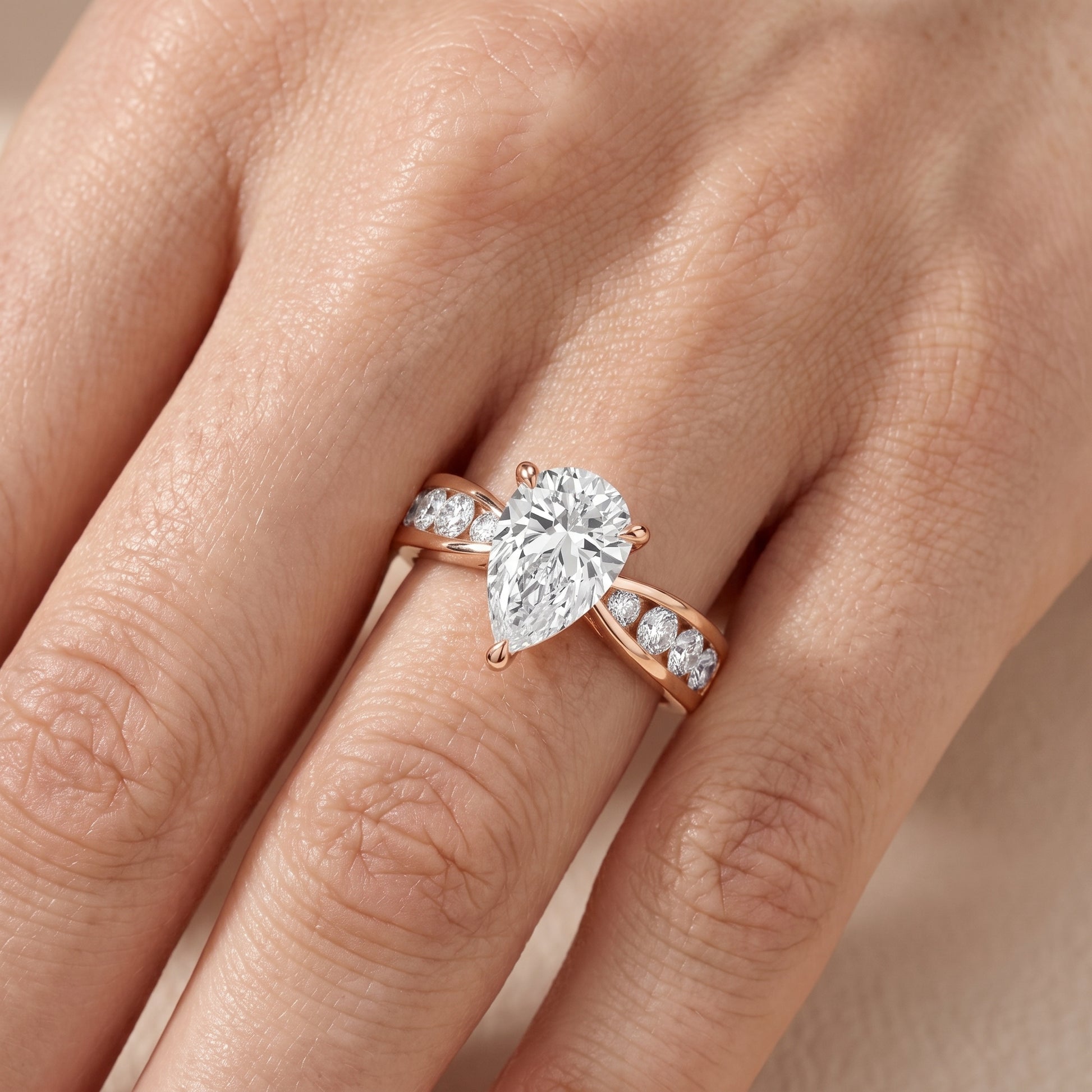 Noor Channel Set Sidestone Pear Diamond Engagement Ring in Rose Gold - lifestyle.jpg