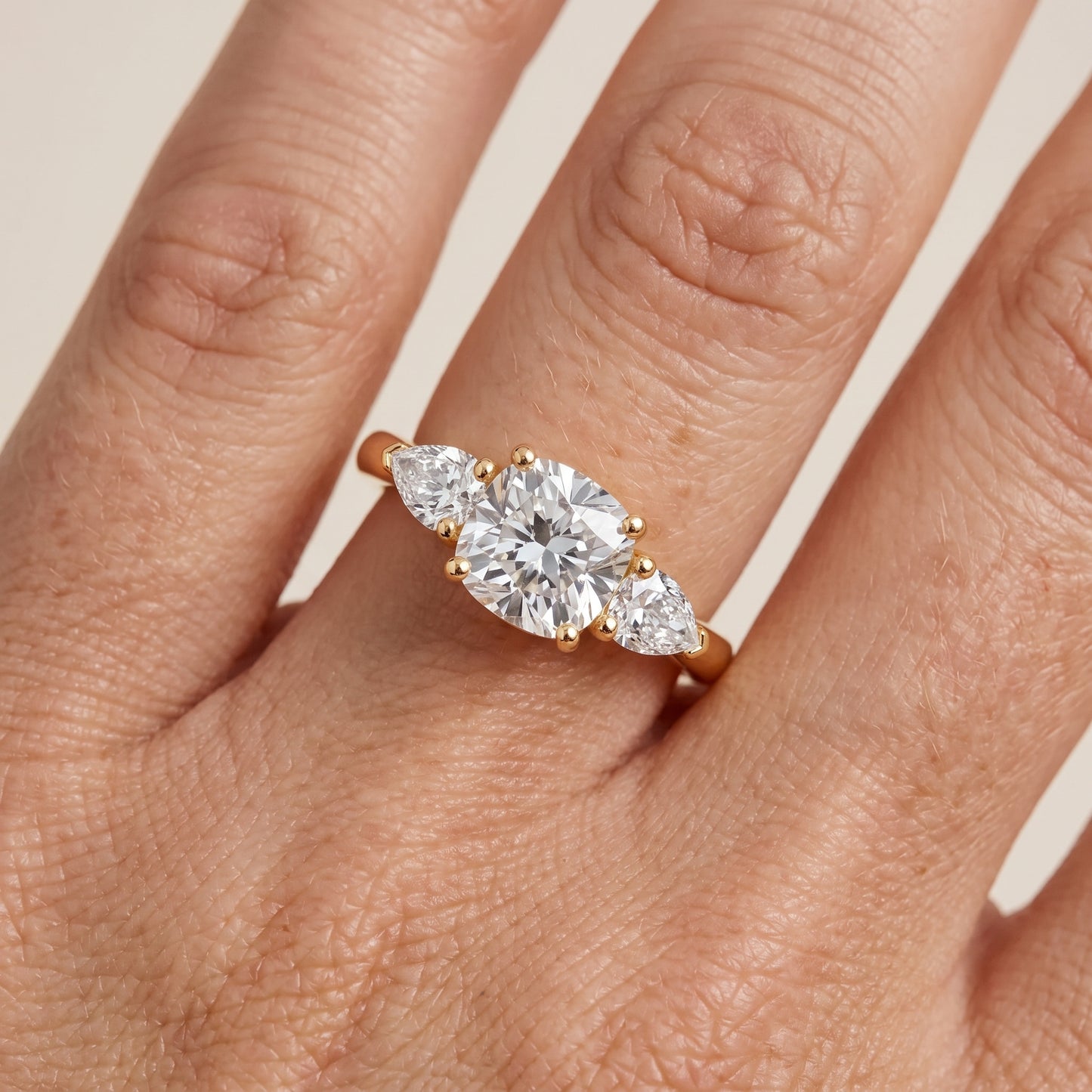 Mirabel Three-Stone Cushion Diamond Engagement Ring in Yellow Gold - lifestyle.jpg