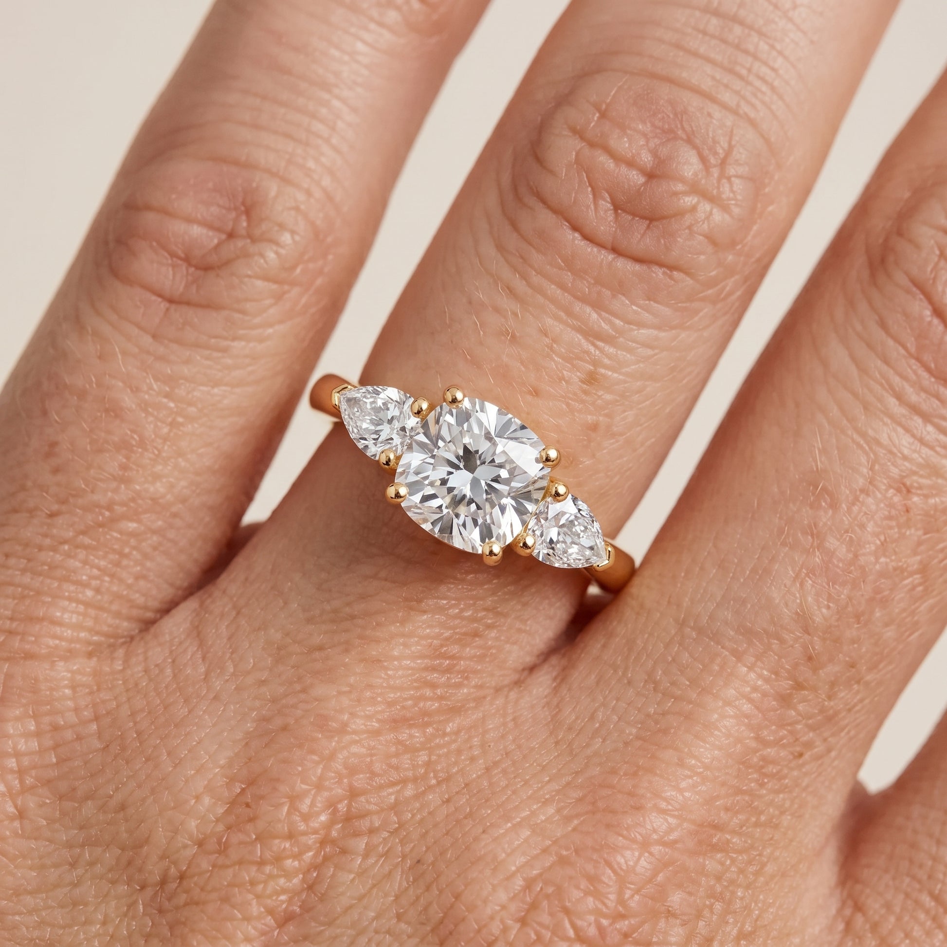 Mirabel Three-Stone Cushion Diamond Engagement Ring in Yellow Gold - lifestyle.jpg