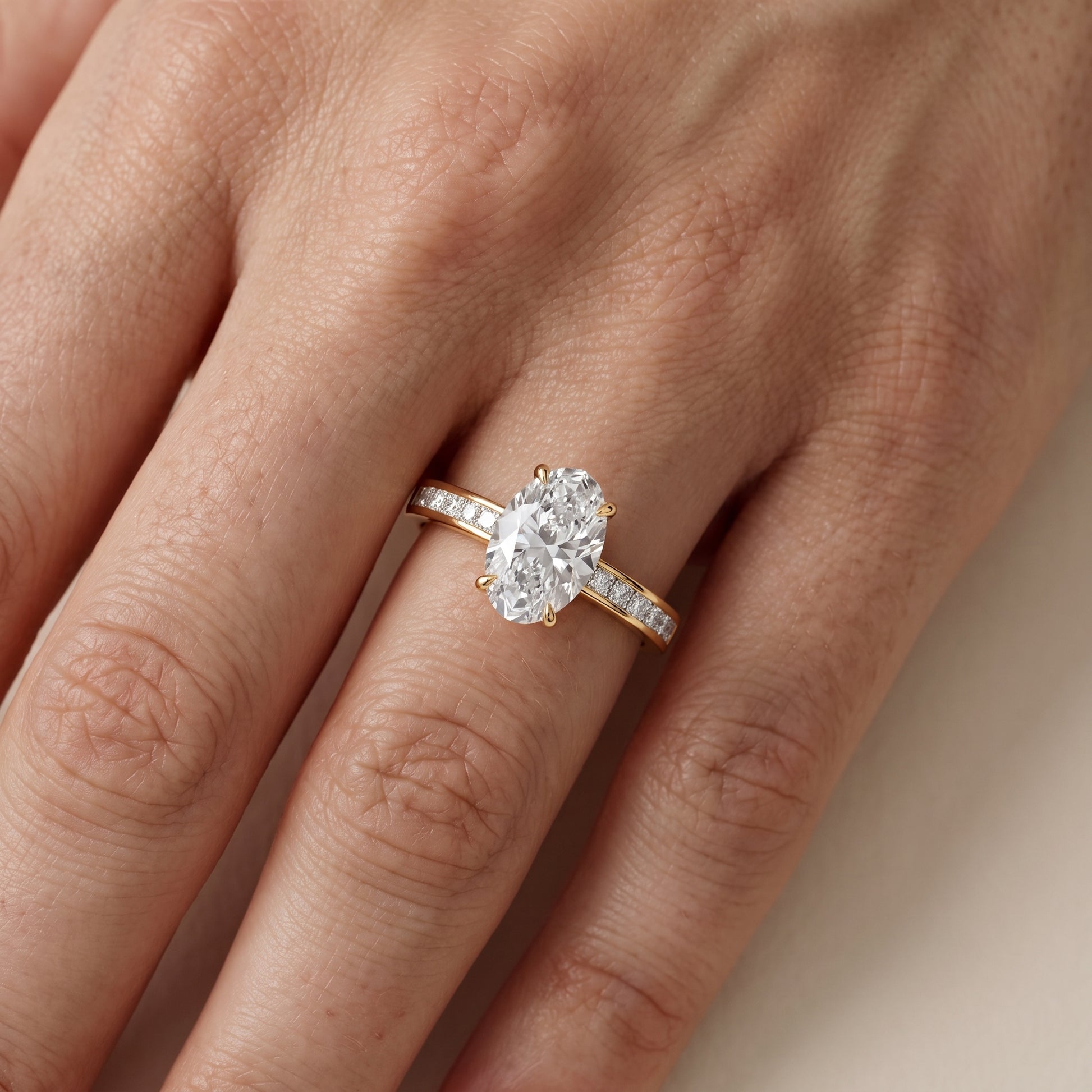 Maren Sidestone Channel Set Oval Diamond Engagement Ring in Yellow Gold - lifestyle.jpg