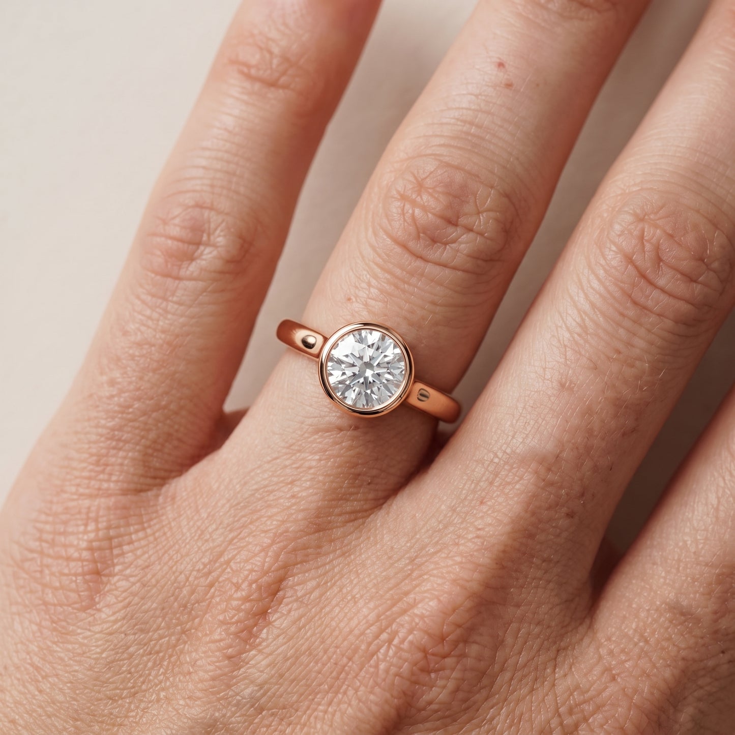 Jolie Bezel Solitaire Round Diamond Engagement Ring in Rose Gold - lifestyle.jpg