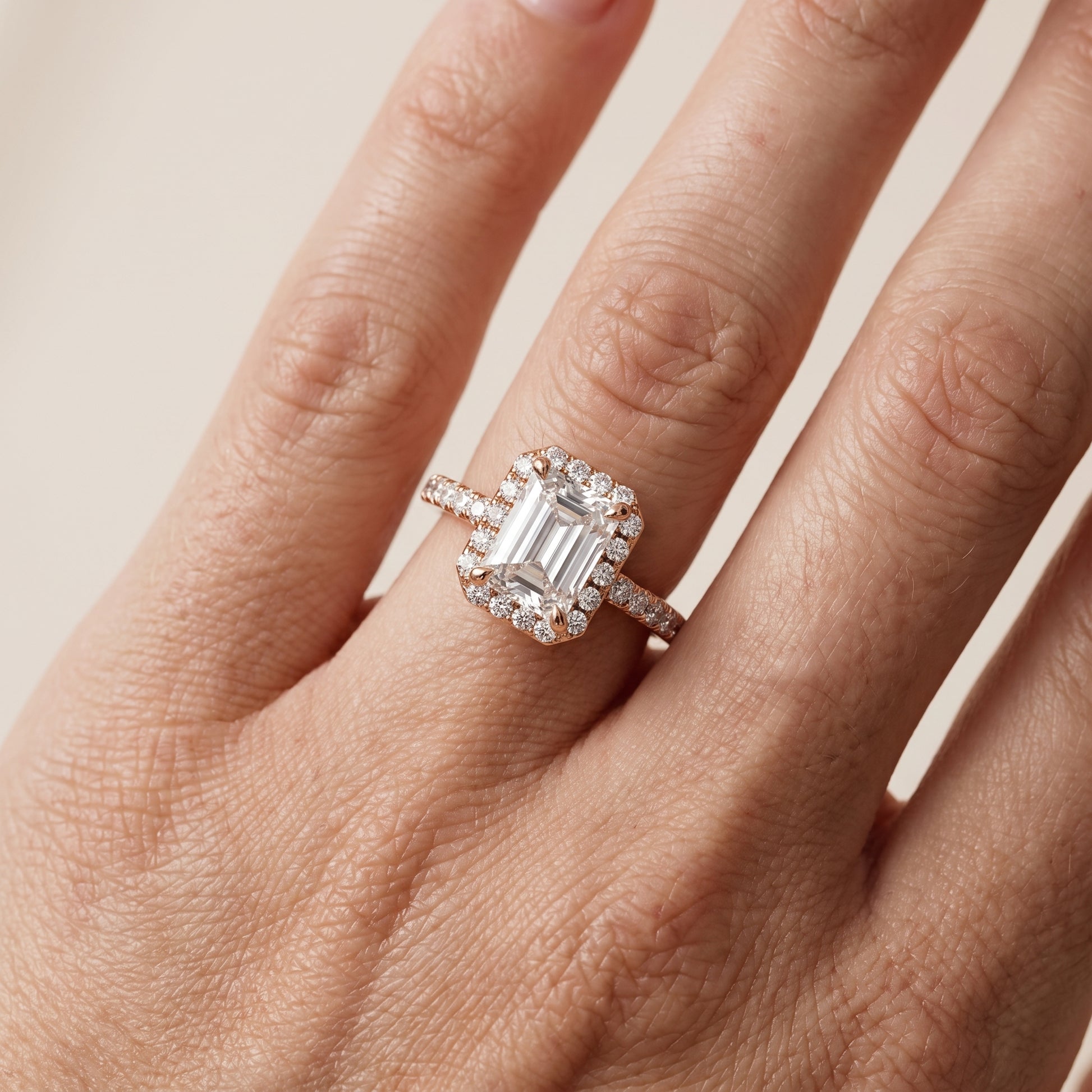 Amara Halo Claw Prong Emerald Diamond Ring in Rose Gold - lifestyle.jpg