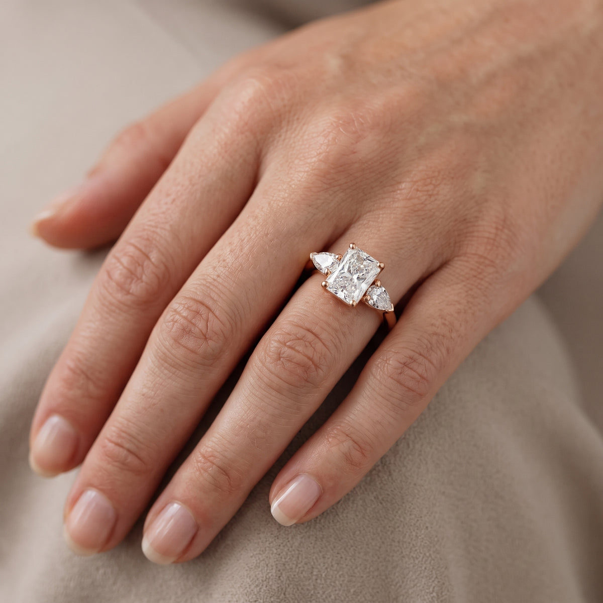 Sophia Three-Stone Radiant Diamond Engagement Ring in Rose Gold - lifestyle.jpg