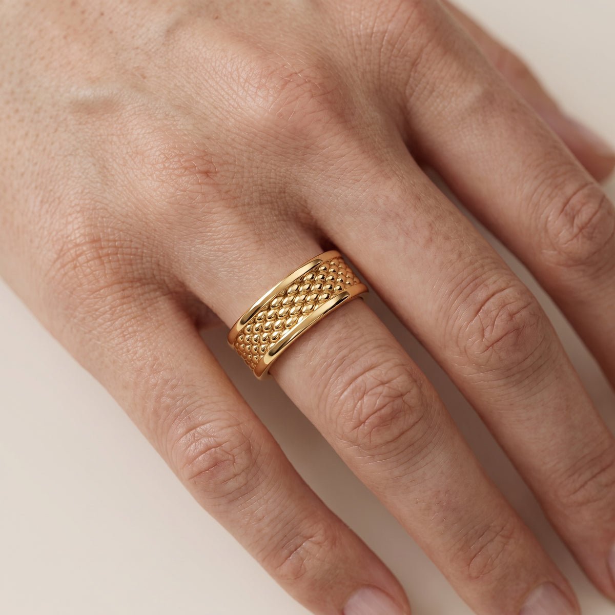 Cordelia Carved Step Edge Wedding Band in Yellow Gold - lifestyle.jpg