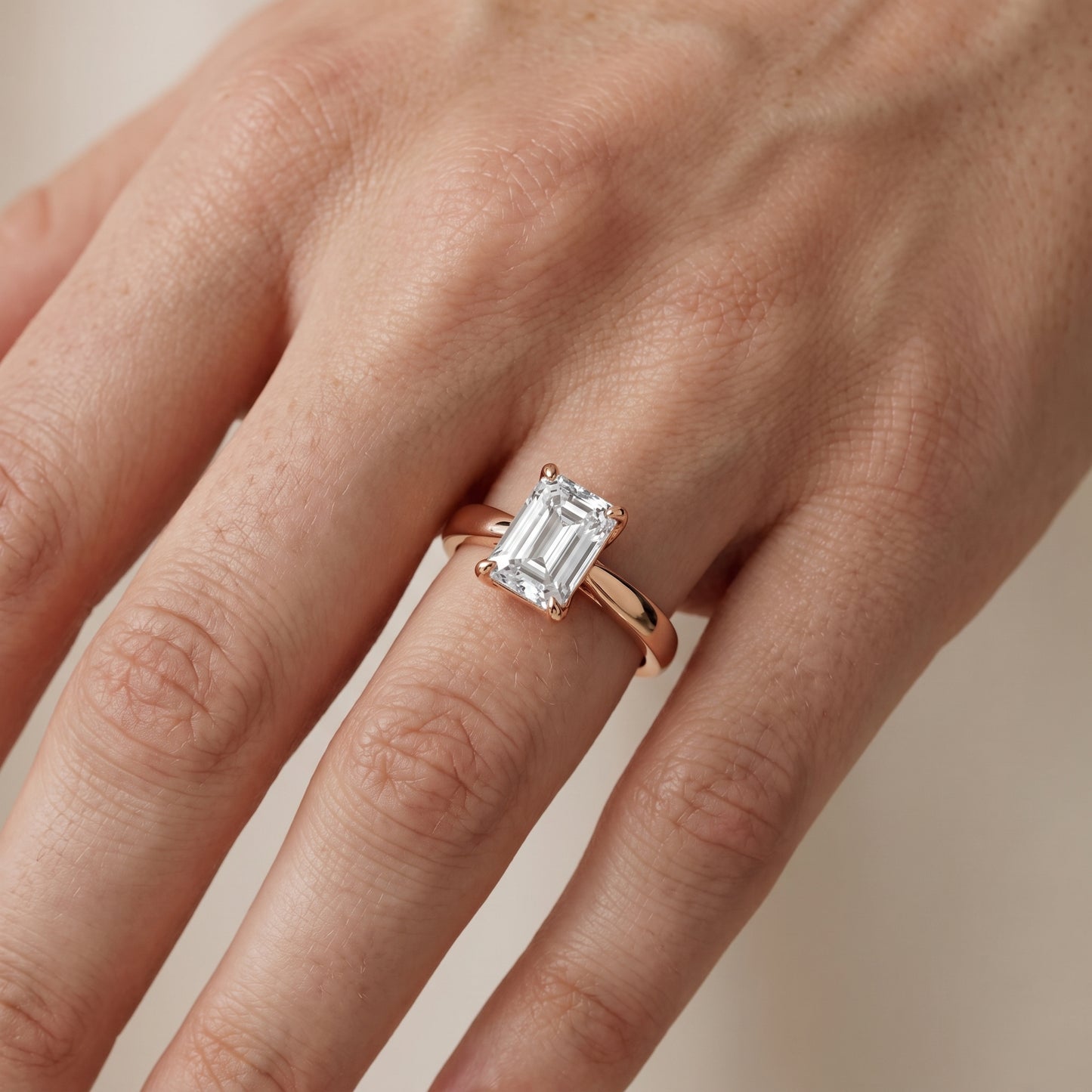 Lucia Solitaire Six-Prong Emerald Diamond Engagement Ring in Rose Gold - lifestyle.jpg