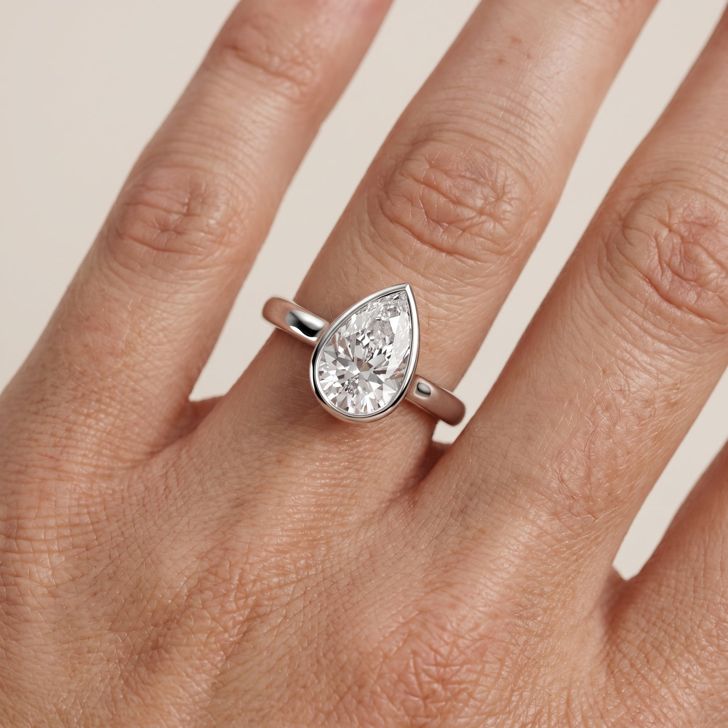 Jolie Bezel Solitaire Pear Diamond Engagement Ring in Silver - lifestyle.jpg