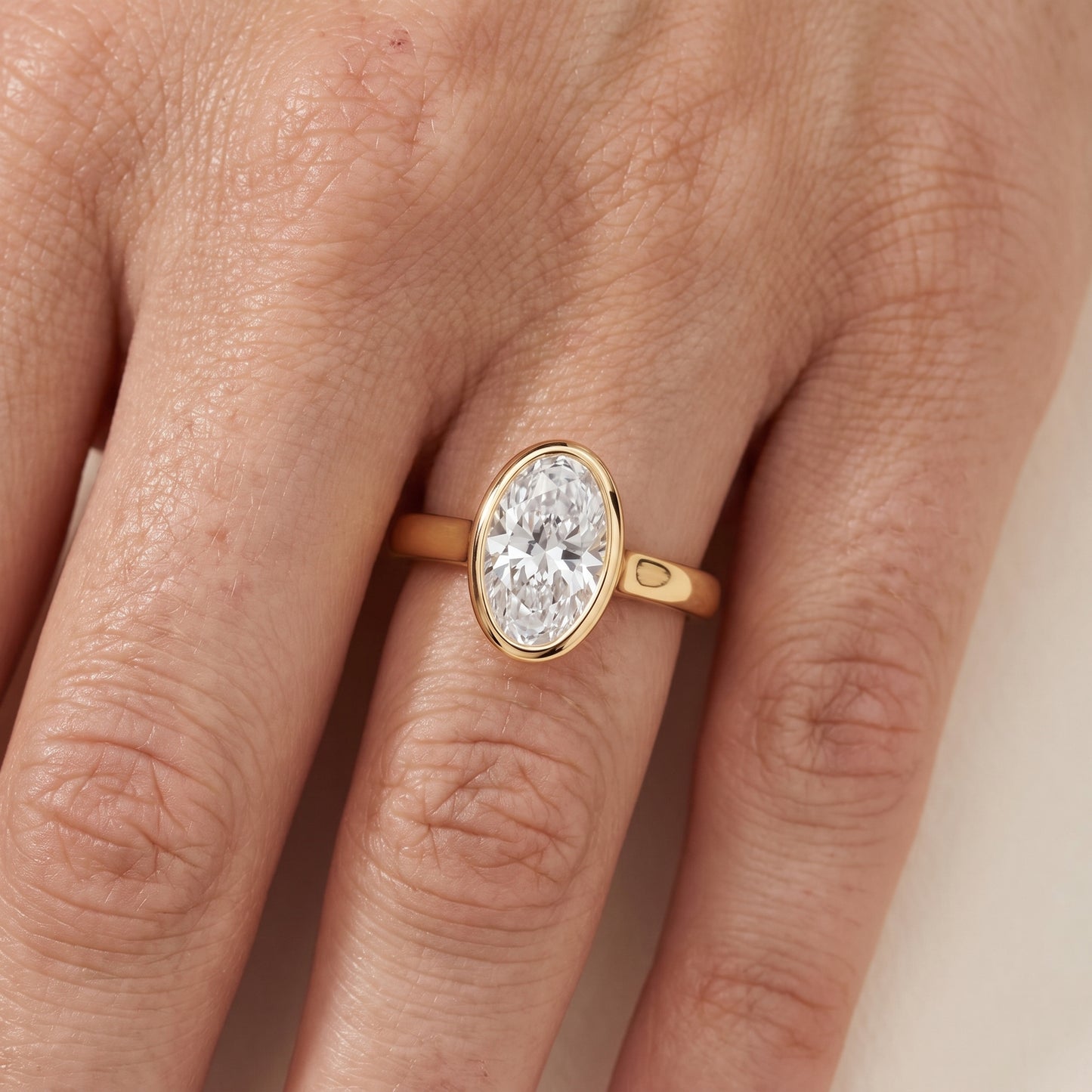 Jolie Bezel Solitaire Oval Diamond Engagement Ring in Yellow Gold - lifestyle.jpg