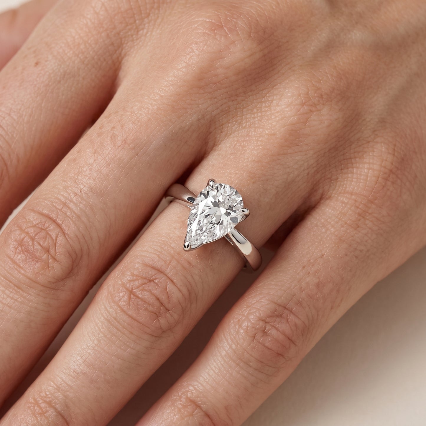 Lucia Solitaire Six-Prong Pear Diamond Engagement Ring in Silver - lifestyle.jpg