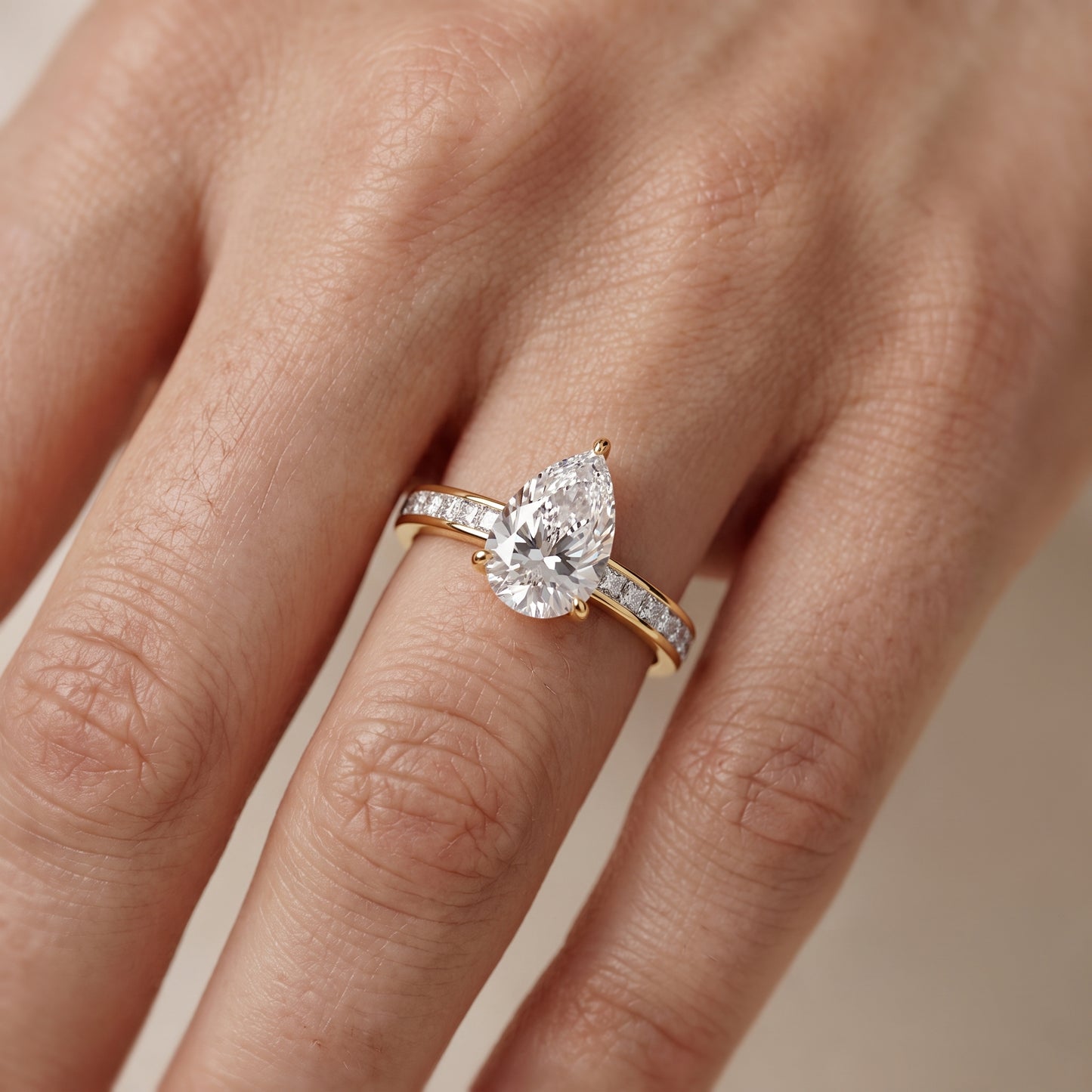 Brielle Channel Set Solitaire Pear Diamond Ring in Yellow Gold - lifestyle.jpg