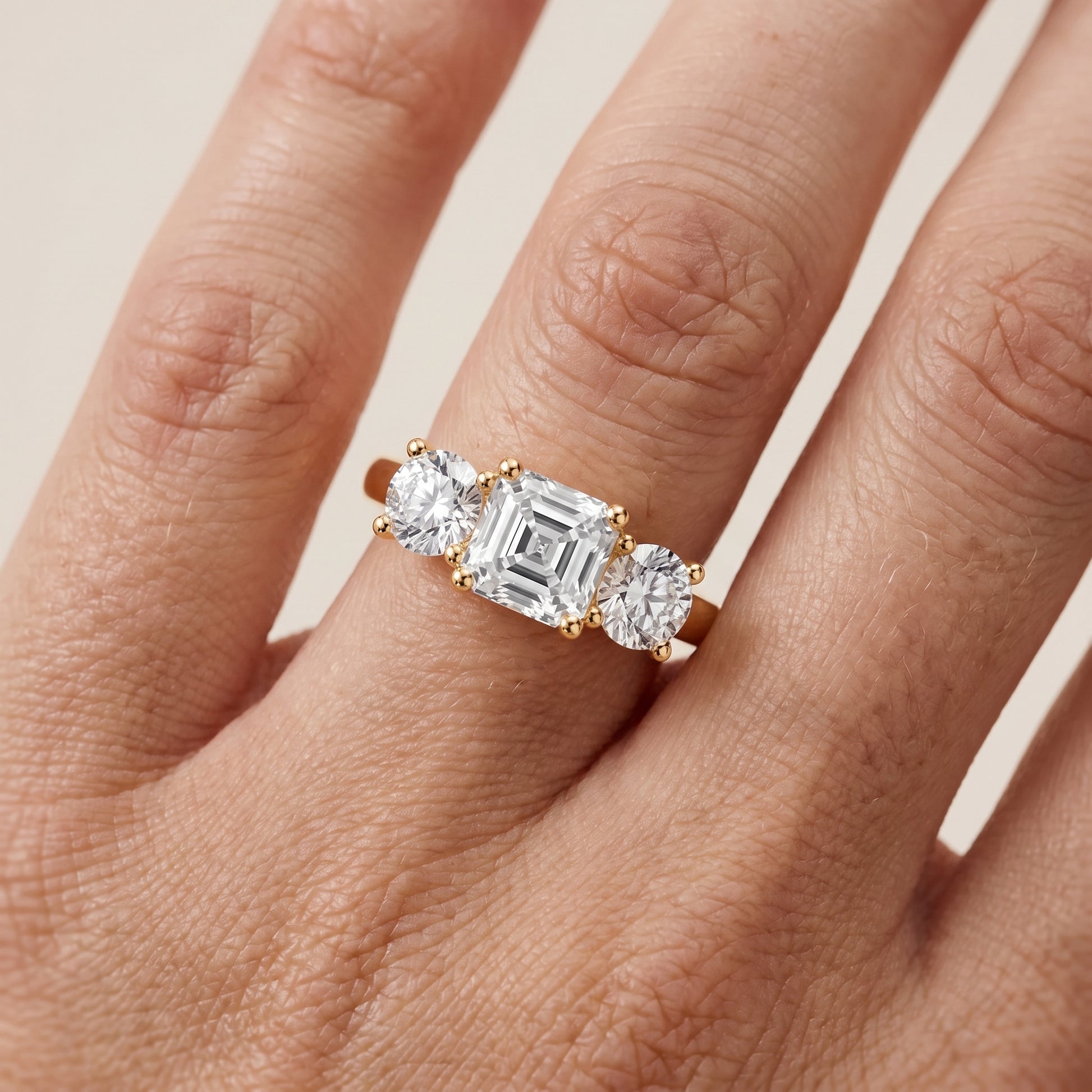 Callie Three-Stone Trellis Asscher Diamond Ring in Yellow Gold - lifestyle.jpg