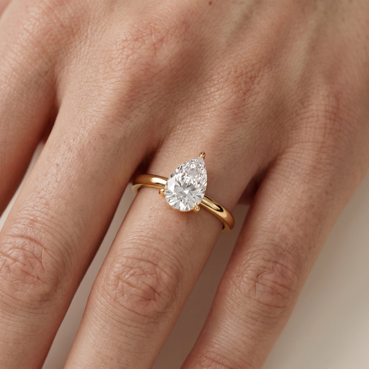Lyla Petite Solitaire Pear Diamond Engagement Ring in Yellow Gold - lifestyle.jpg