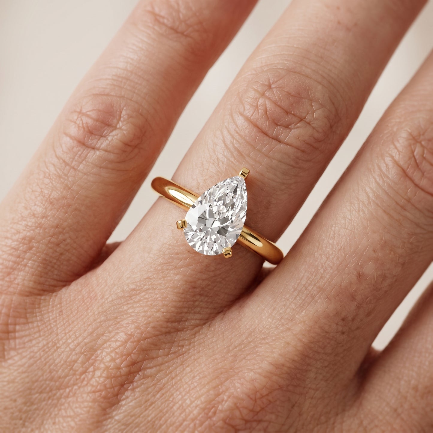 Amira Six-Prong Solitaire Pear Diamond Engagement Ring in Yellow Gold - lifestyle.jpg