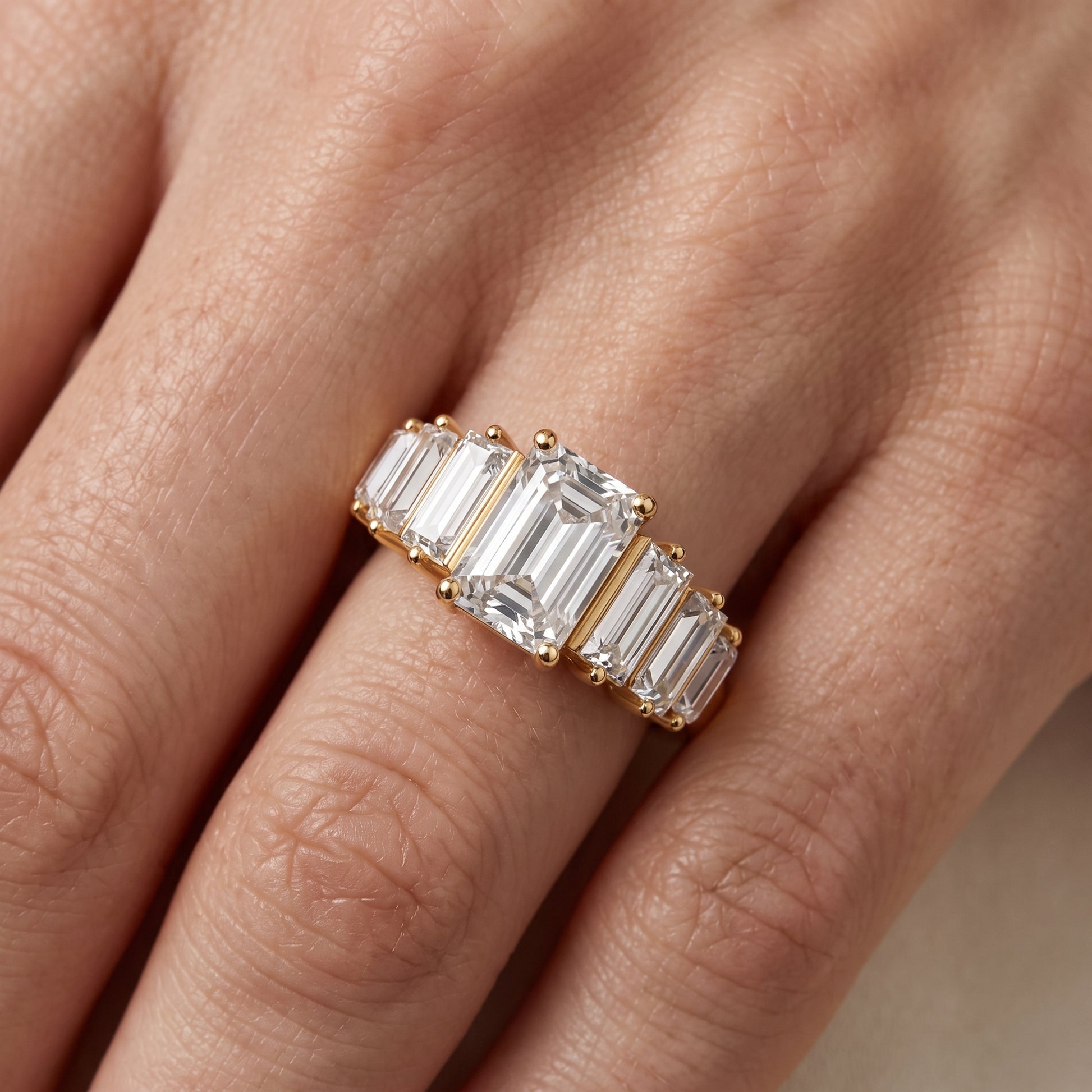 Mara Sidestone Baguette Accent Emerald Diamond Engagement Ring in Yellow Gold - lifestyle.jpg