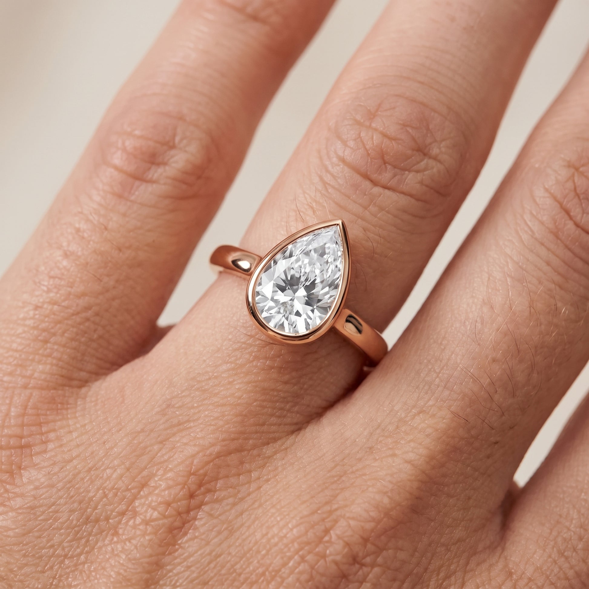 Jolie Bezel Solitaire Pear Diamond Engagement Ring in Rose Gold - lifestyle.jpg