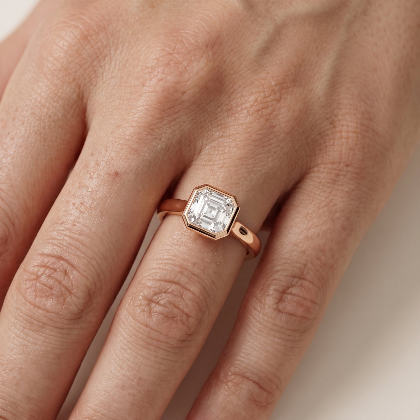 Jolie Bezel Solitaire Asscher Diamond Engagement Ring in Rose Gold - lifestyle.jpg