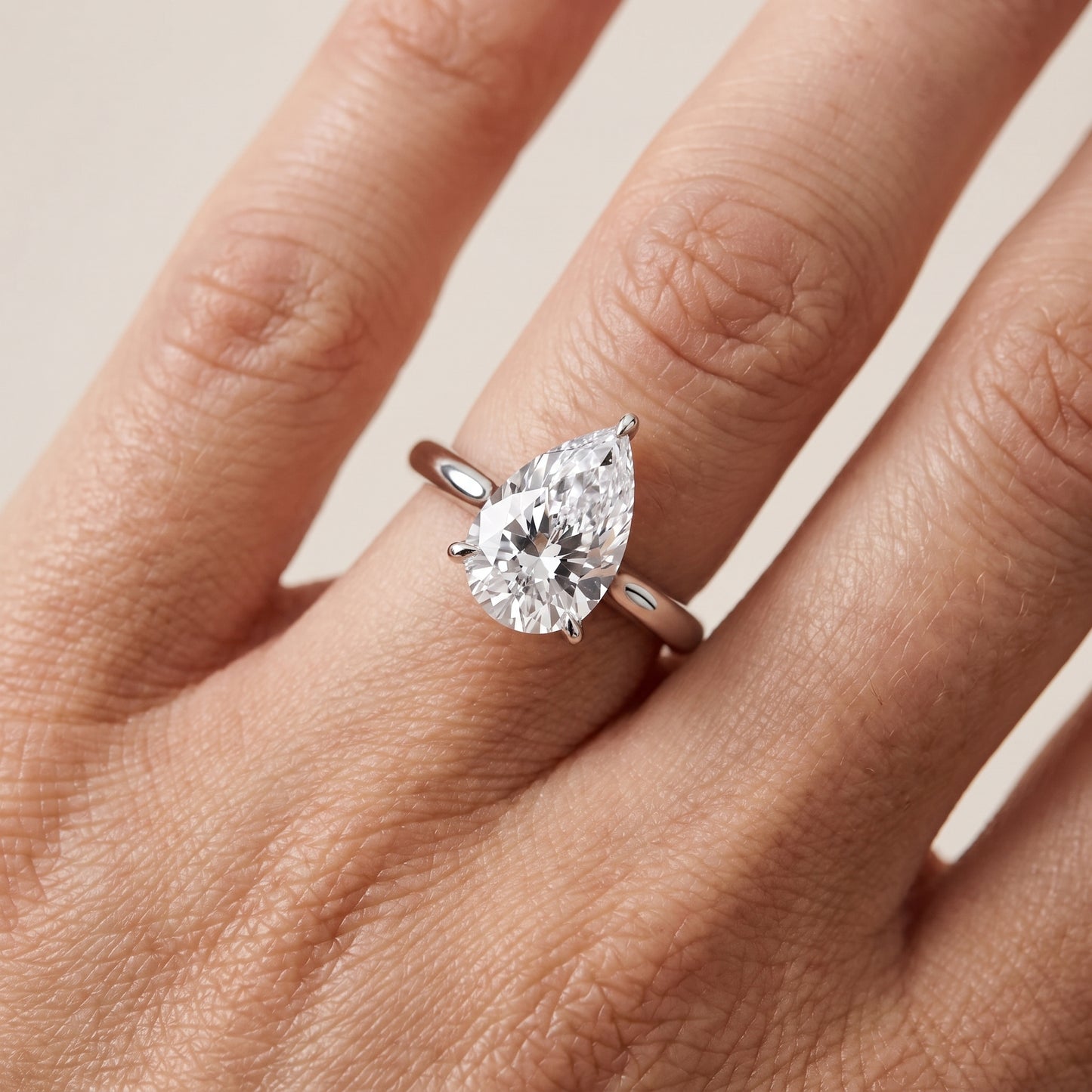 Evie Solitaire Six-Prong Pear Diamond Engagement Ring in Platinum - lifestyle.jpg