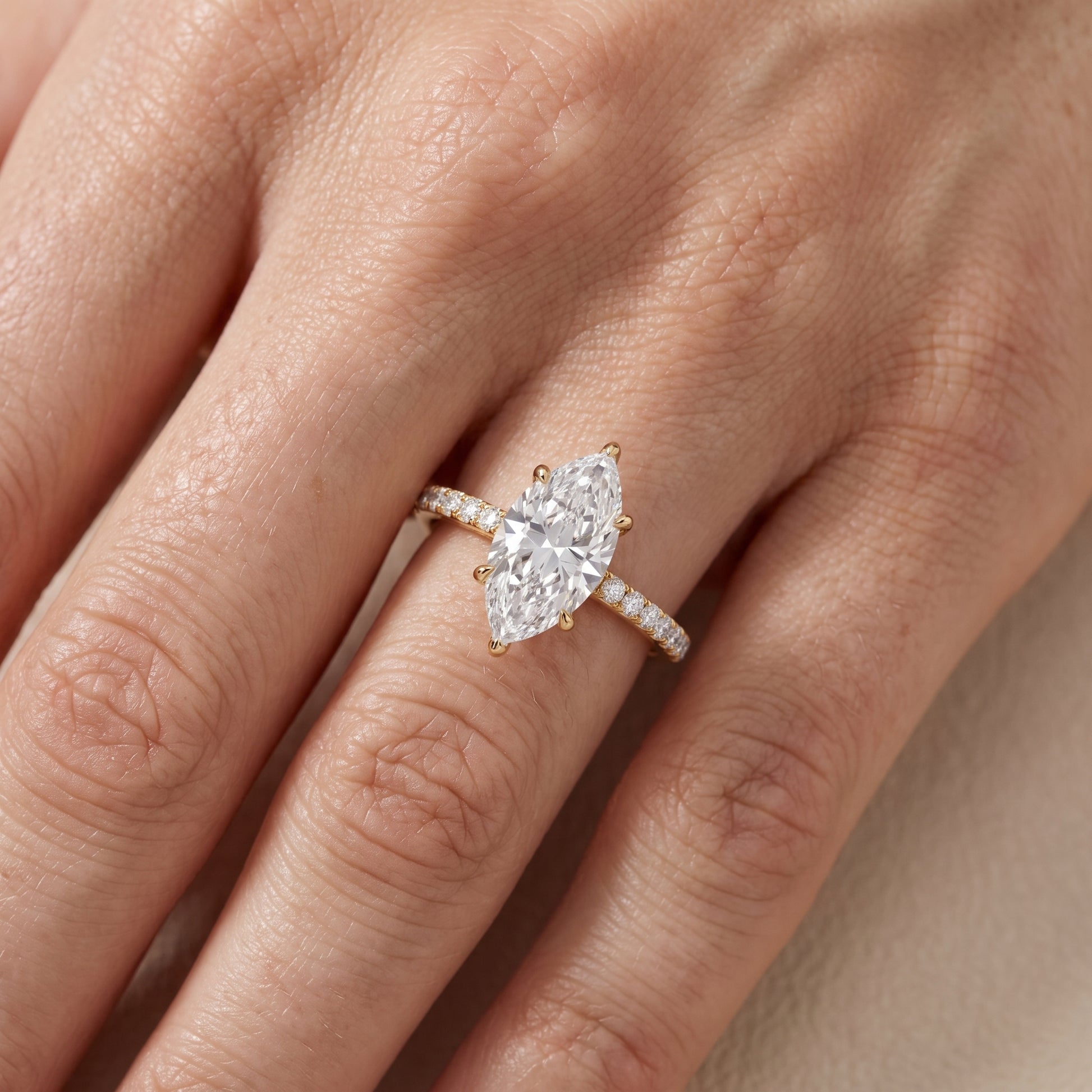 Ione Solitaire Pavé Marquise Diamond Engagement Ring in Yellow Gold - lifestyle.jpg