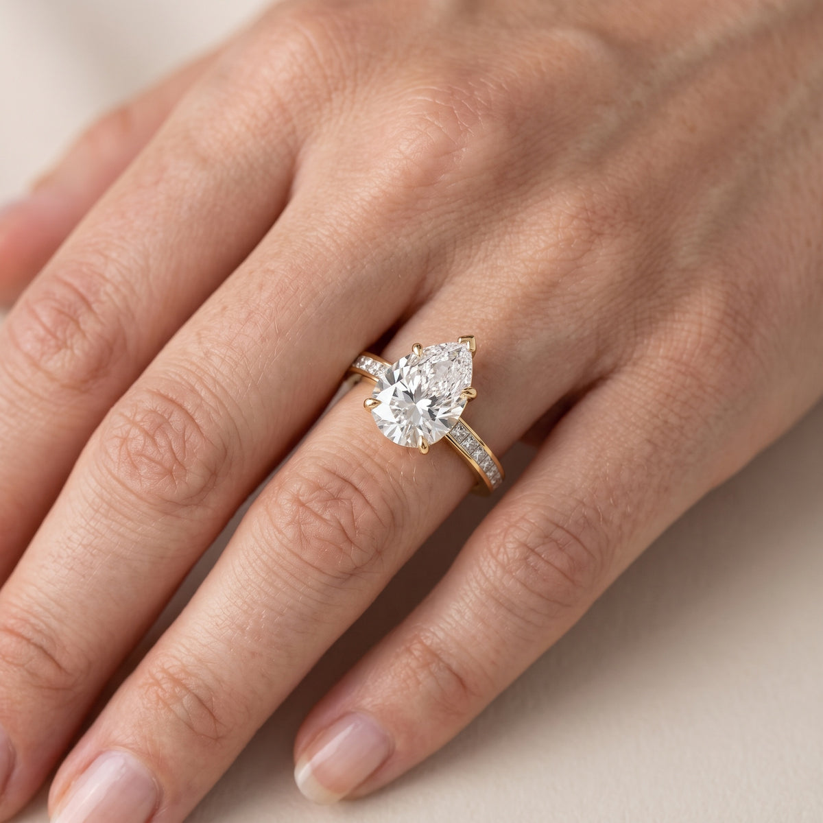 Freja Channel Set Pear Diamond Engagement Ring in Yellow Gold - lifestyle.jpg