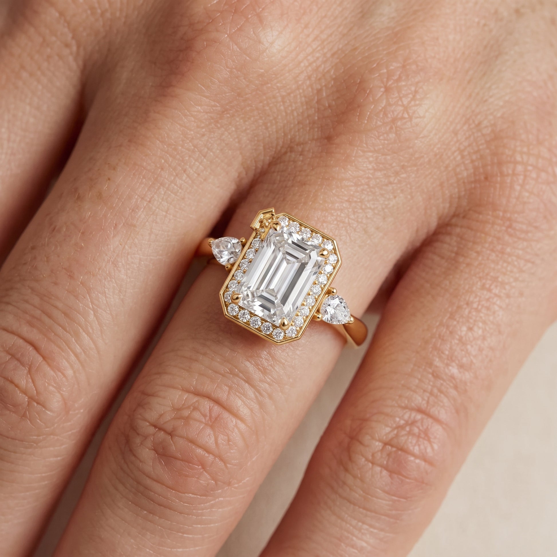 Eliza Halo Sidestone Emerald Diamond Engagement Ring in Yellow Gold - lifestyle.jpg