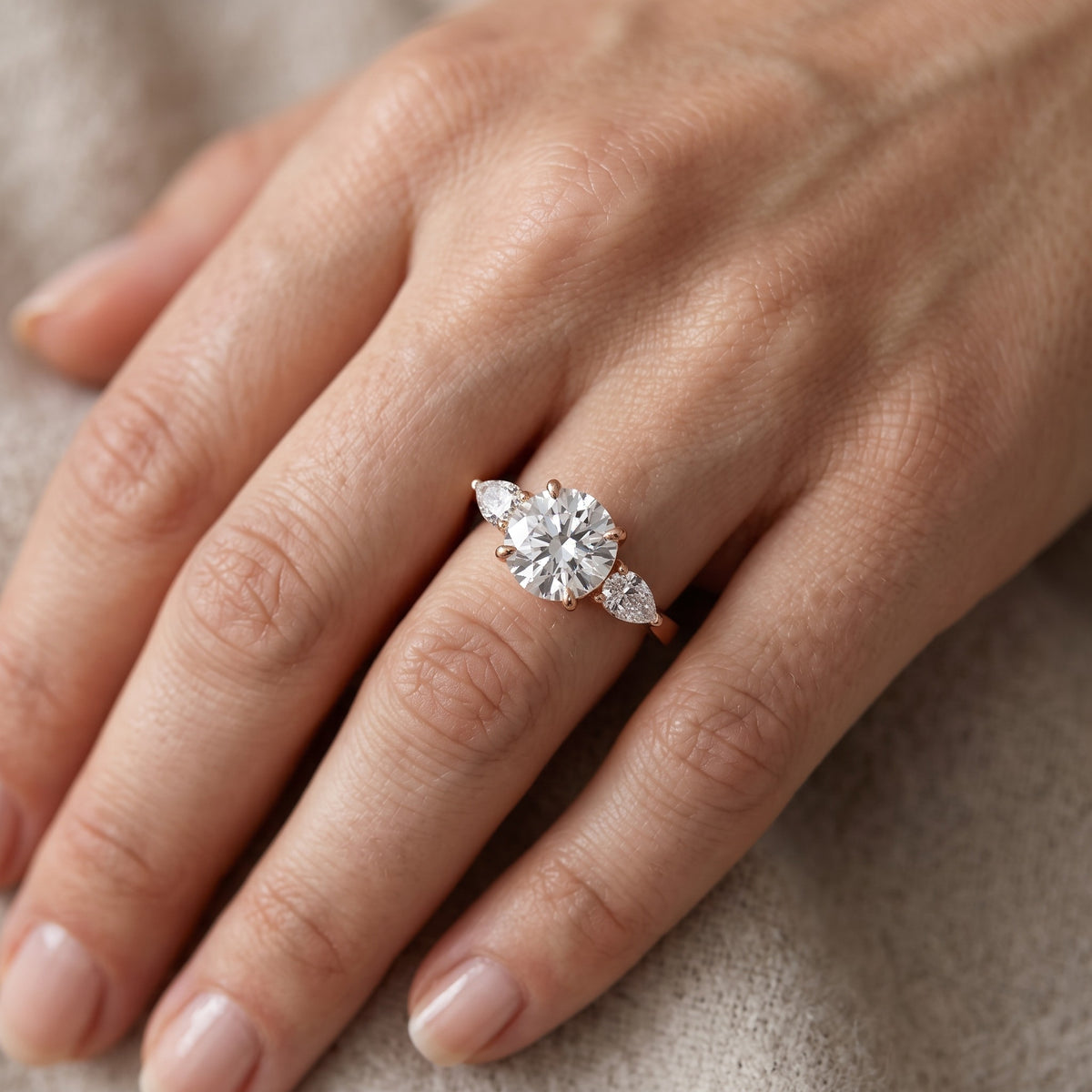 Grace Three Stone Round Diamond Engagement Ring in Rose Gold - lifestyle.jpg