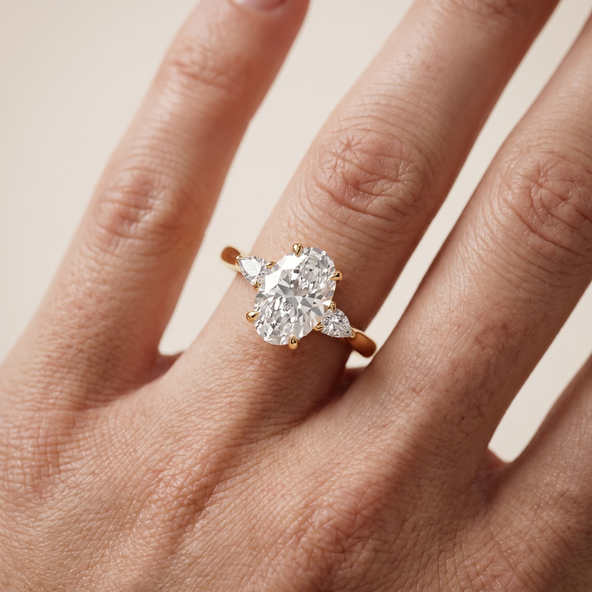 Leila Three-Stone Oval Diamond Engagement Ring in Yellow Gold - lifestyle.jpg