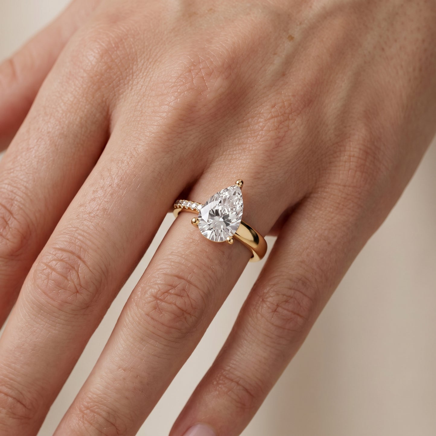 Rosie Solitaire Basket Pear Diamond Engagement Ring in Yellow Gold - lifestyle.jpg